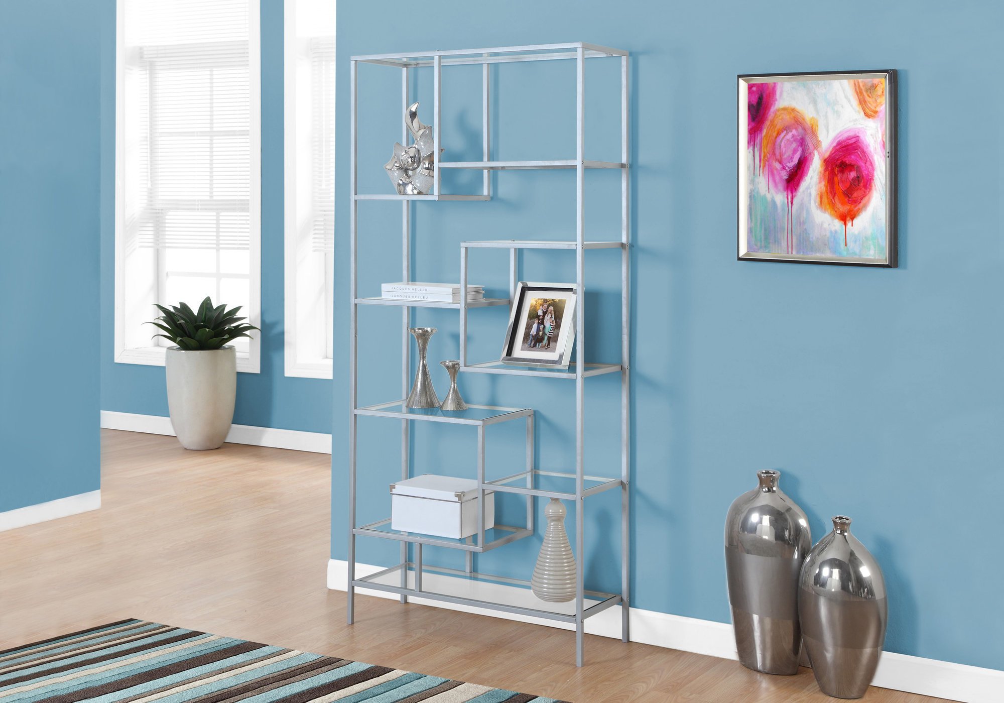 A stylish 72-inch metal and tempered glass bookcase with nine shelves, showcasing books and decorative items in a modern living space.