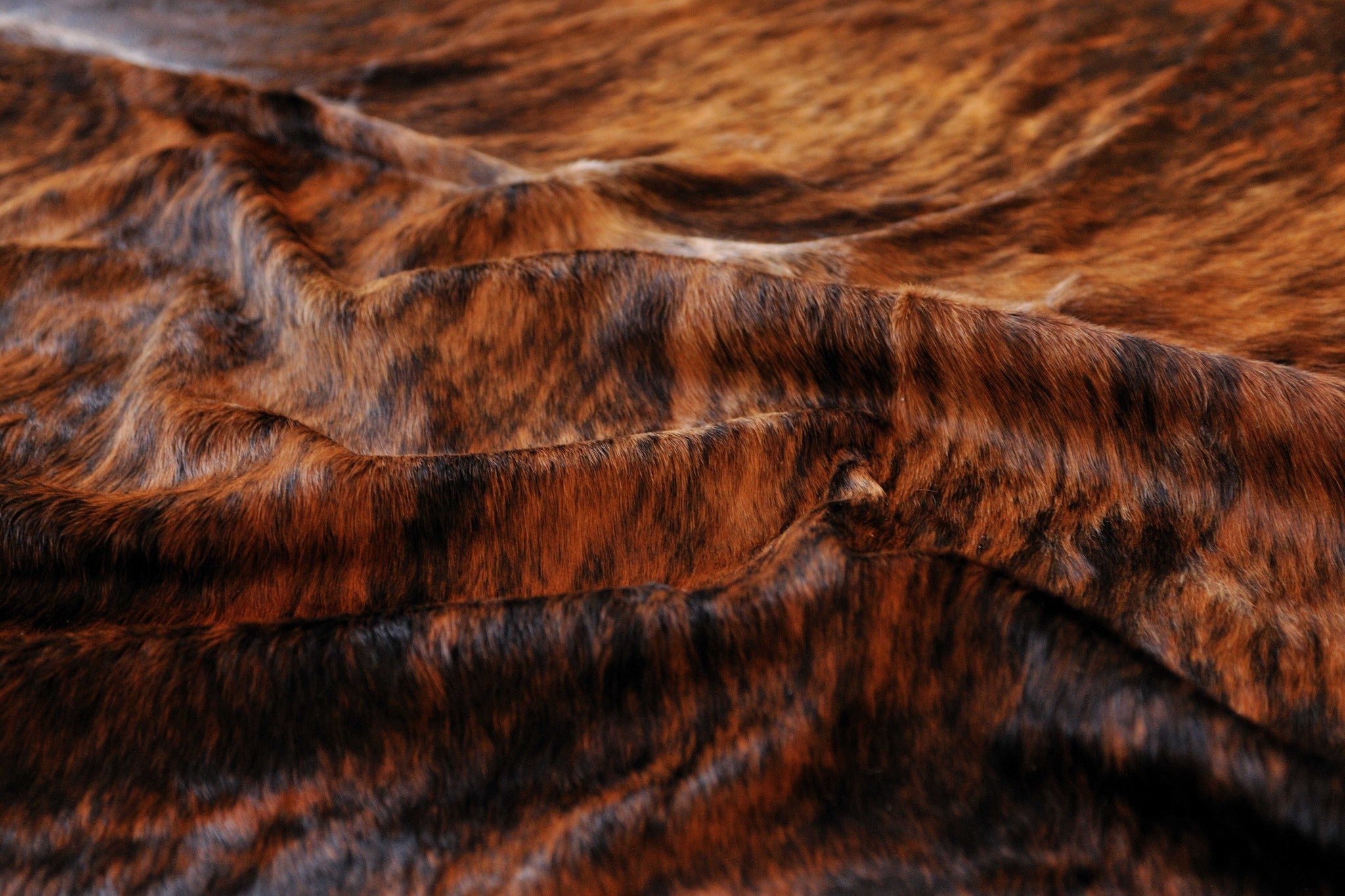 Luxurious 72x84 inches Classic and Brindle Cowhide Rug, showcasing rich colors and soft texture, perfect for enhancing home decor.