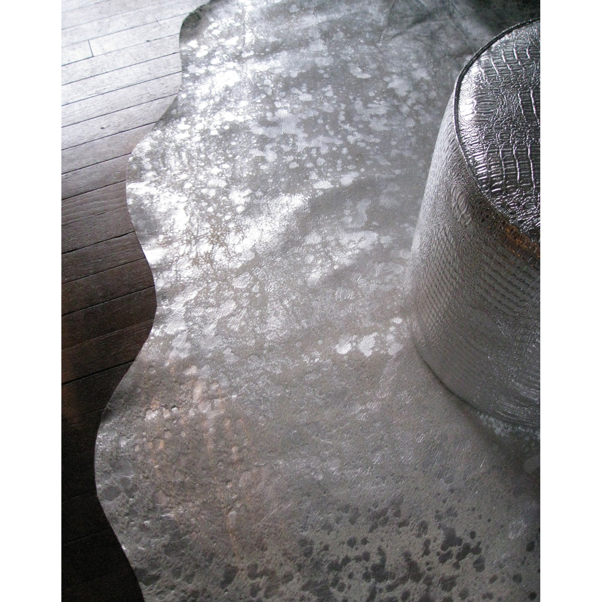 A luxurious gray and silver cowhide area rug measuring 72x84 inches, showcasing its rich texture and elegant design, perfect for contemporary interiors.