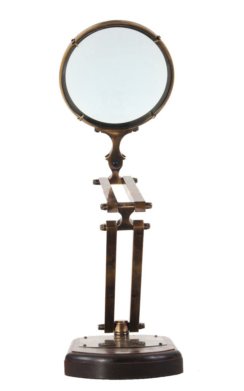 A beautifully crafted 7.5x14.5x28 inches brass magnifying glass with a wooden base, showcasing intricate etchings and a shiny finish.