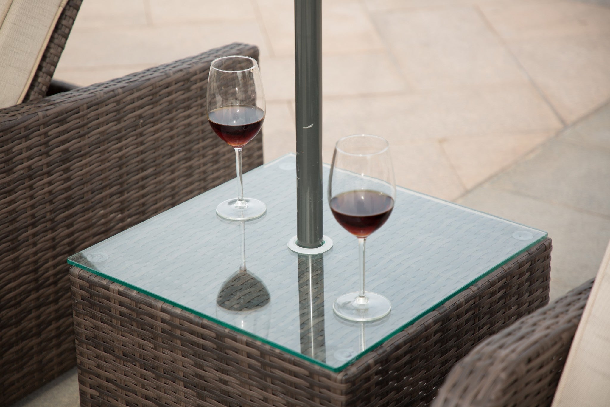 Brown 3-Piece Outdoor Arm Chaise Lounge set featuring two lounges with cushions and a glass-top table, perfect for outdoor relaxation.