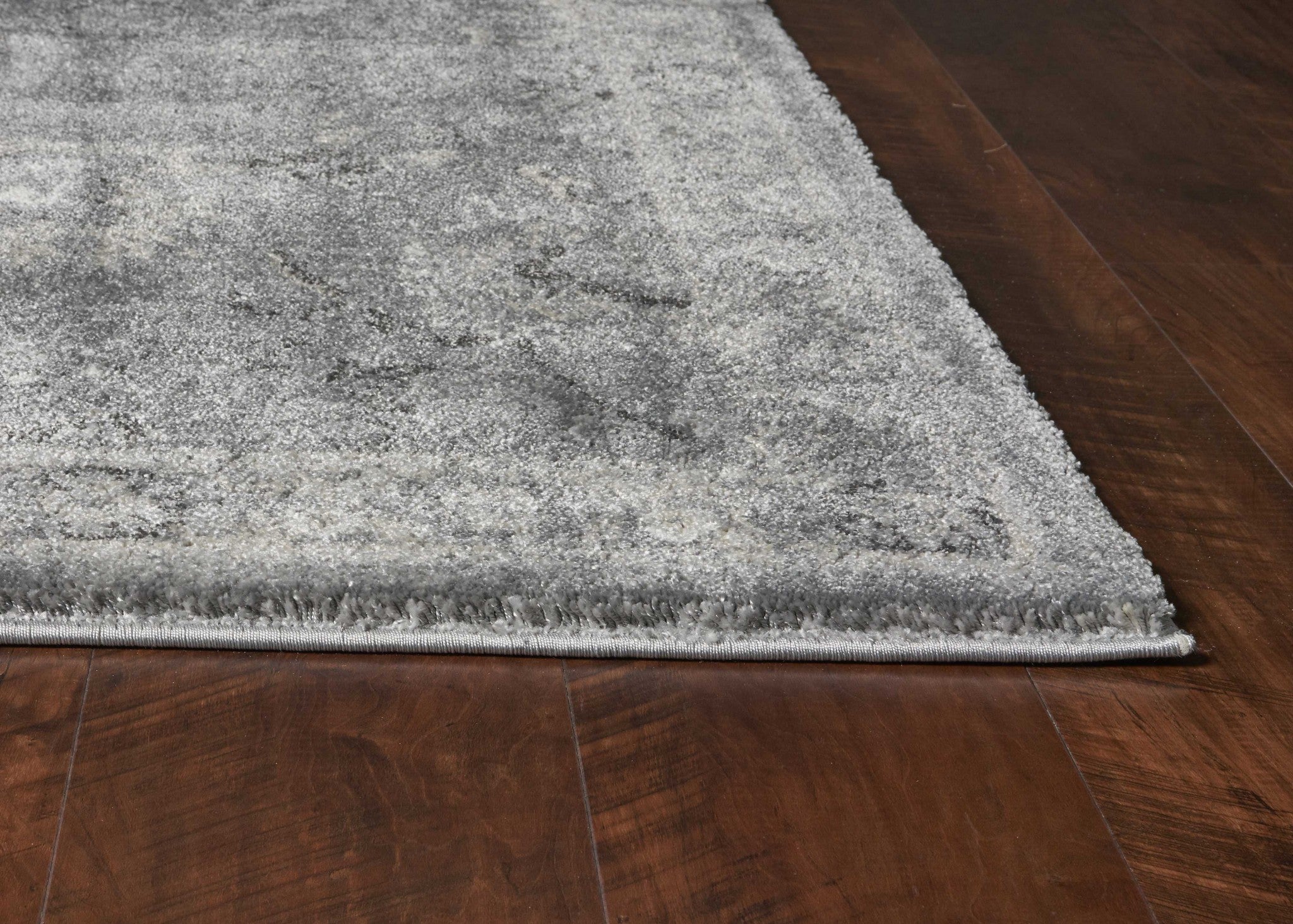 7x9 inches grey polypropylene area rug with a contemporary design, perfect for enhancing living spaces.