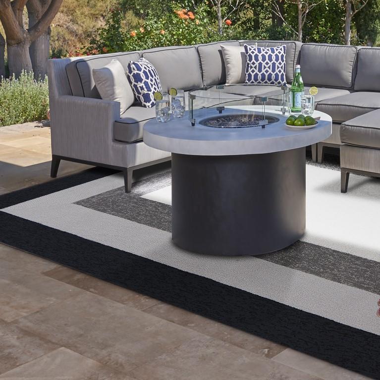 Charcoal grey hand hooked rug with a bordered design, showcasing a plush texture and modern aesthetic, suitable for indoor and outdoor use.