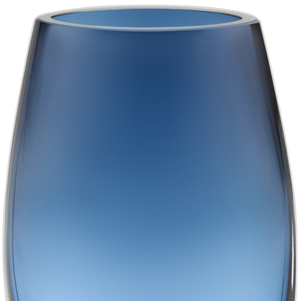 A stunning 8-inch mouth blown crystal oval vase in midnight blue, showcasing its thick walls and elegant design, perfect for floral arrangements.
