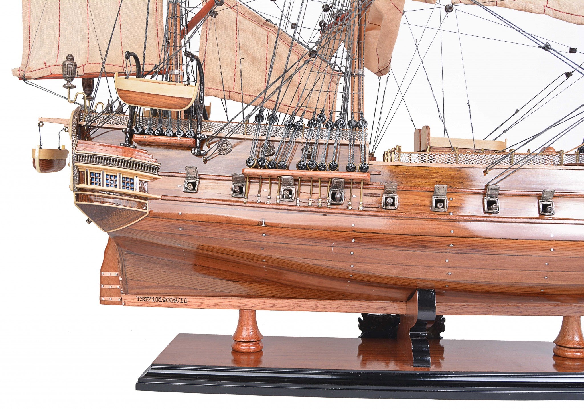 Detailed model of the H.M.S. Surprise, an 18th-century tall ship replica, showcasing intricate wooden craftsmanship and vibrant colors.