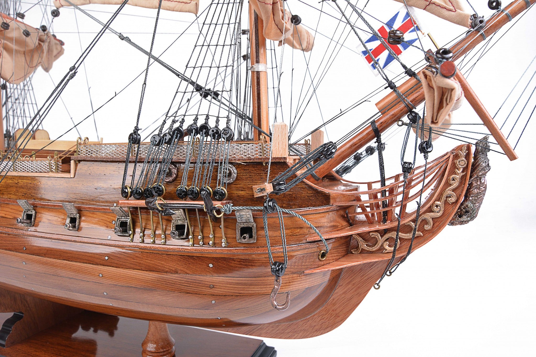 Detailed model of the H.M.S. Surprise, an 18th-century tall ship replica, showcasing intricate wooden craftsmanship and vibrant colors.