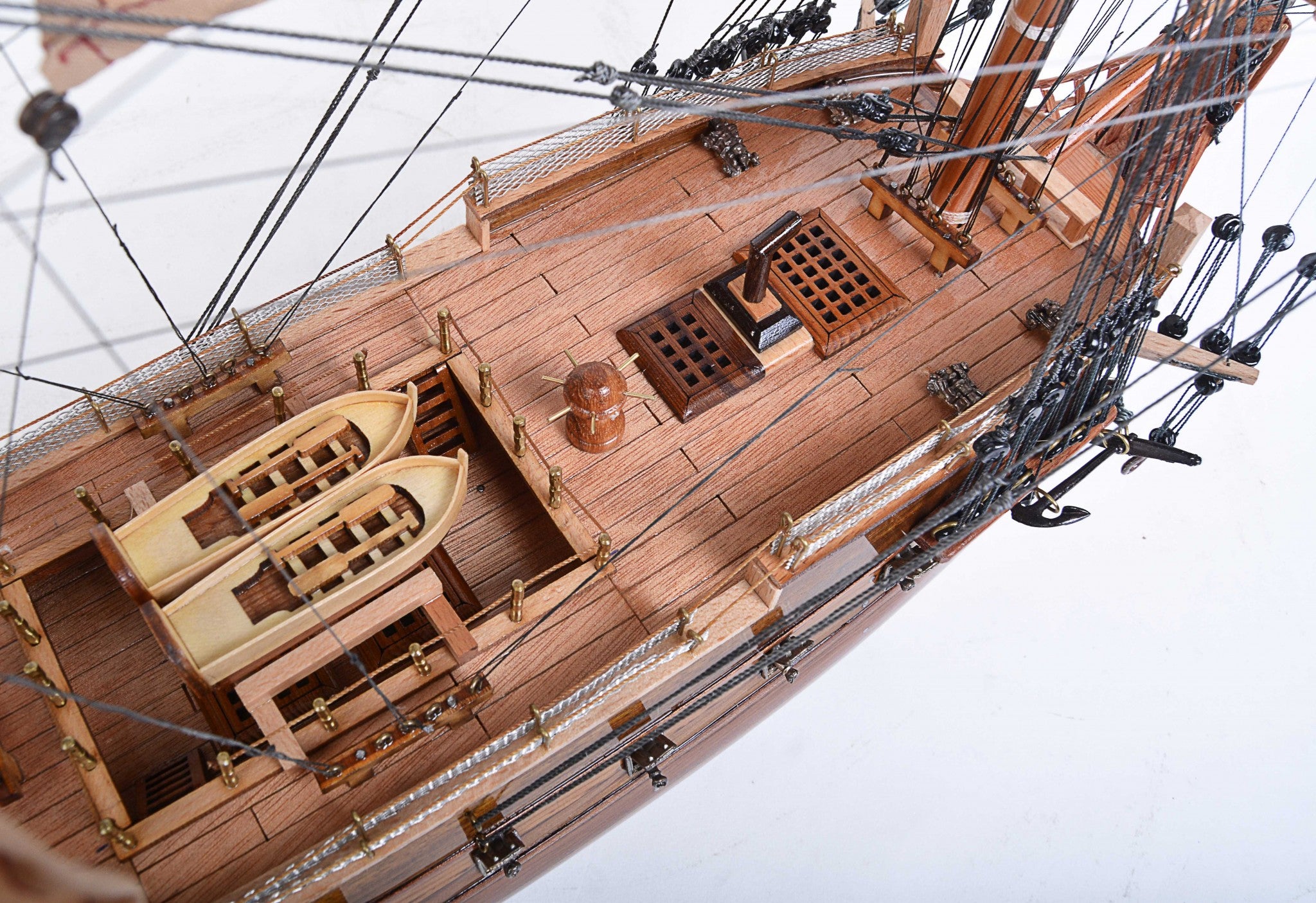 Detailed model of the H.M.S. Surprise, an 18th-century tall ship replica, showcasing intricate wooden craftsmanship and vibrant colors.