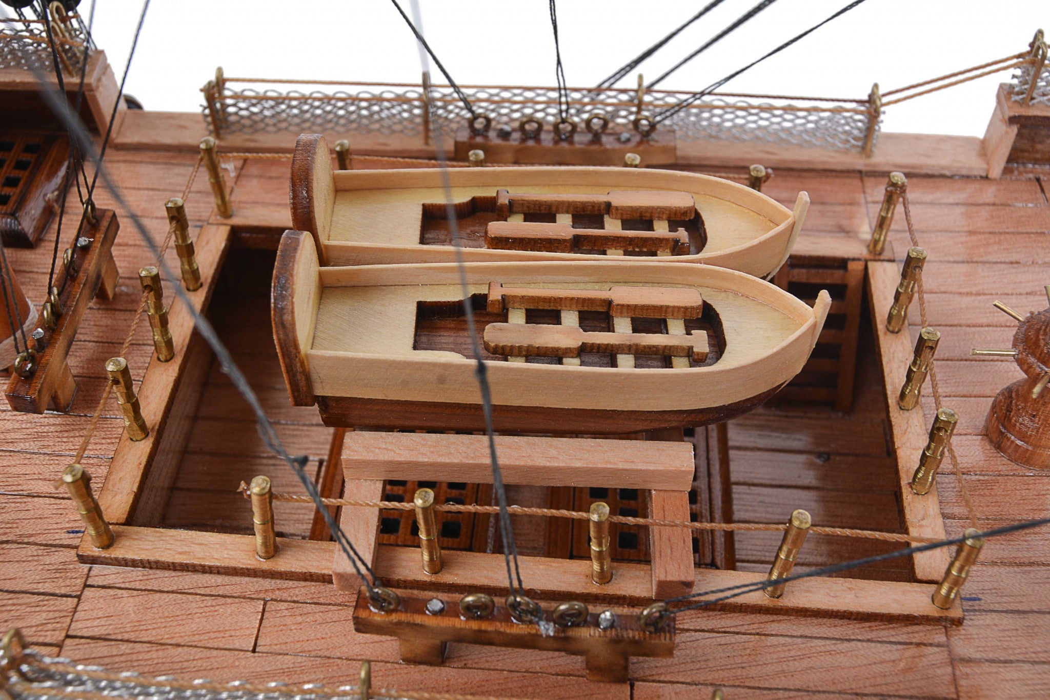 Detailed model of the H.M.S. Surprise, an 18th-century tall ship replica, showcasing intricate wooden craftsmanship and vibrant colors.
