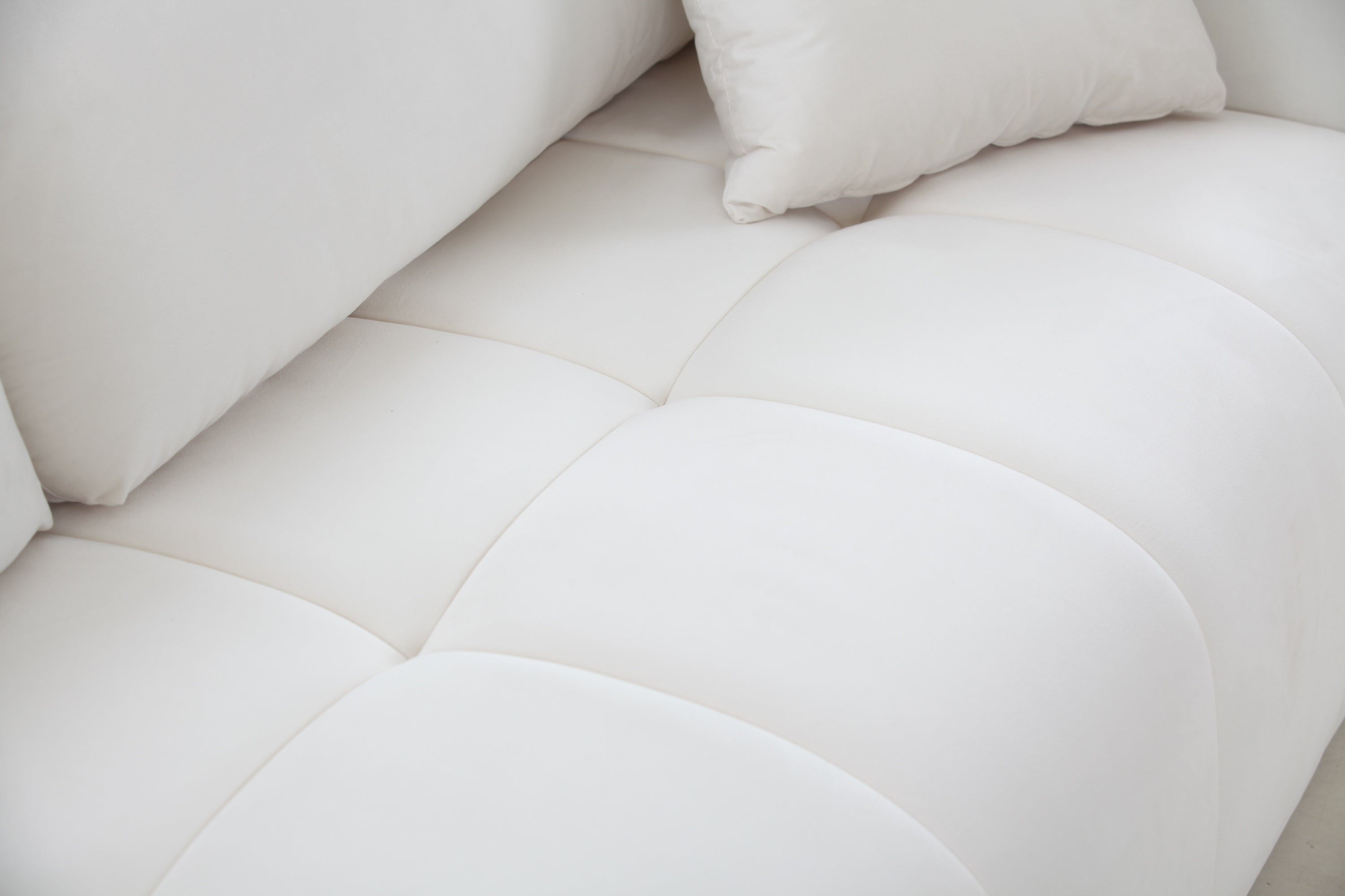 A stylish 85'' modern fabric sectional couch sofa in beige, featuring three soft pillows, perfect for living rooms.