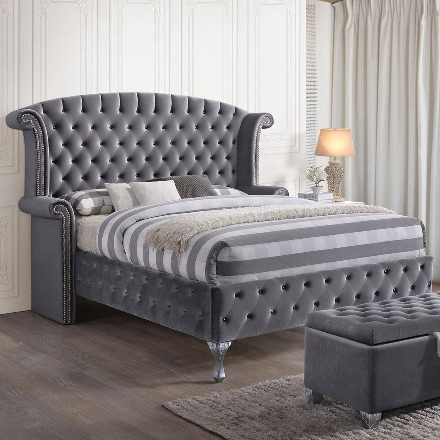 Gray Velvet Queen Bed with padded wingback headboard and button tufting, showcasing a luxurious and elegant design.