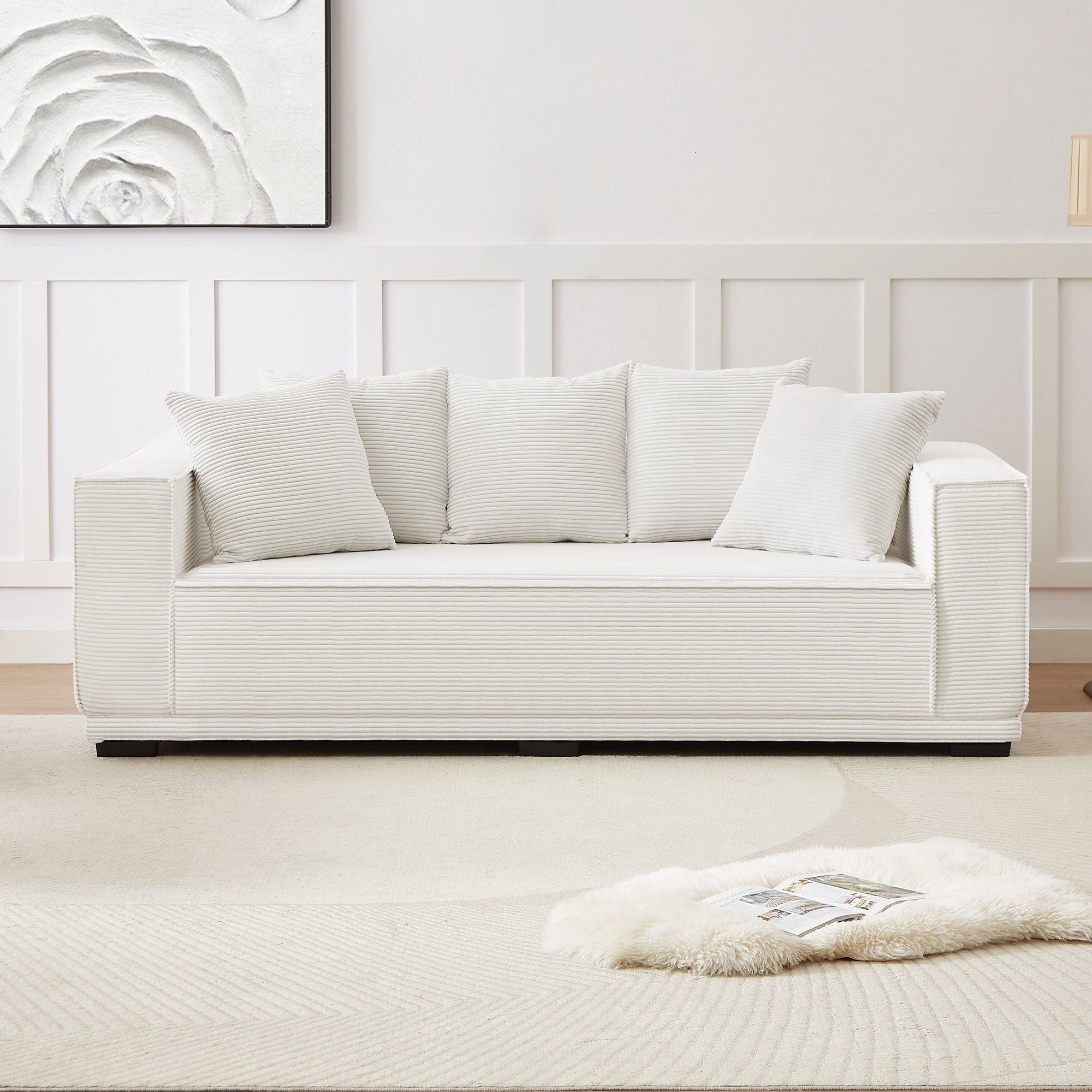 A stylish 88.97'' Mid Century Modern Upholstered Sofa in white corduroy, featuring a sleek design and five matching toss pillows, perfect for modern living rooms.