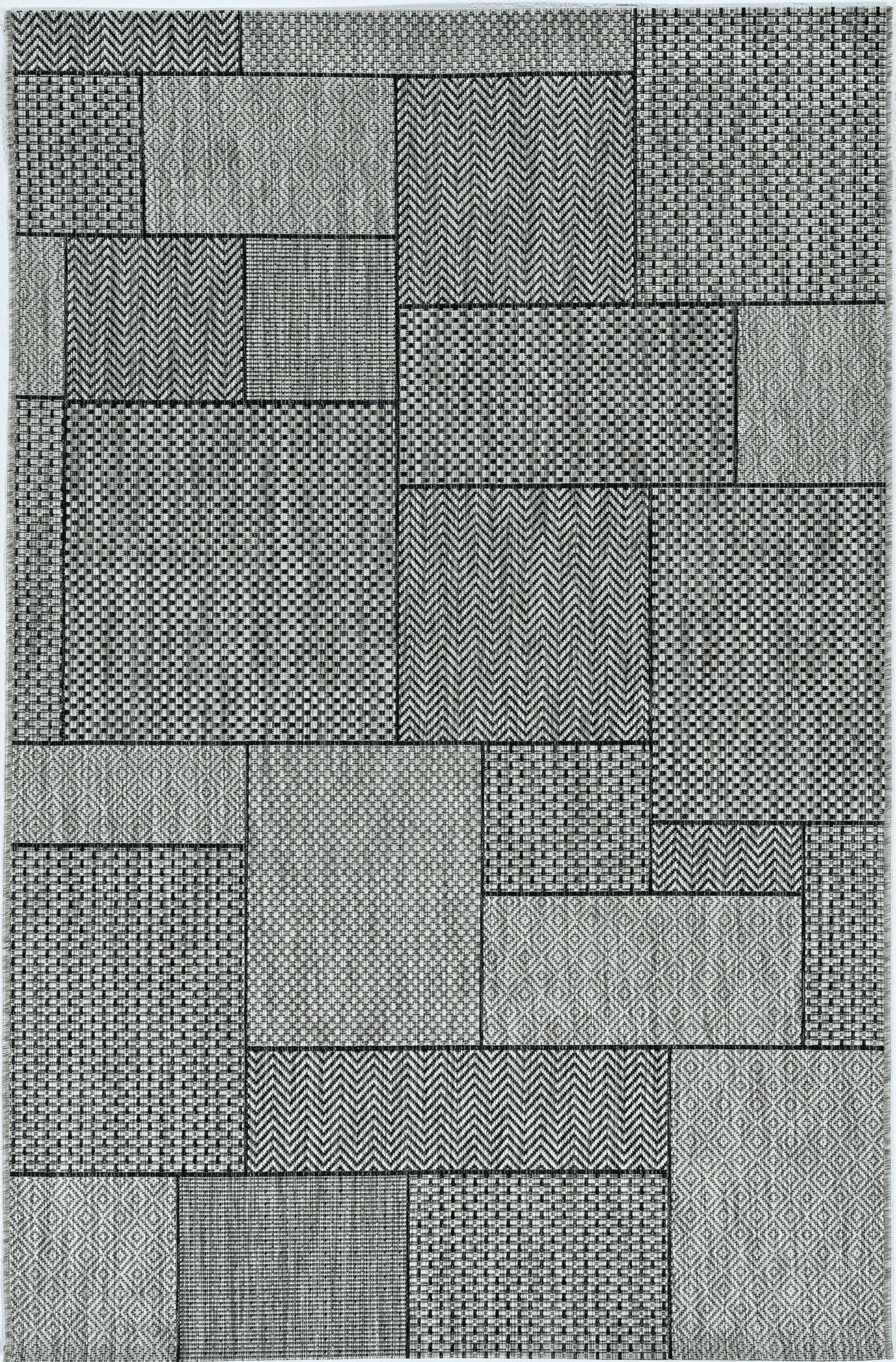 8-inch grey machine woven geometric round rug suitable for indoor and outdoor use, featuring a low pile height and UV-treated polypropylene material.