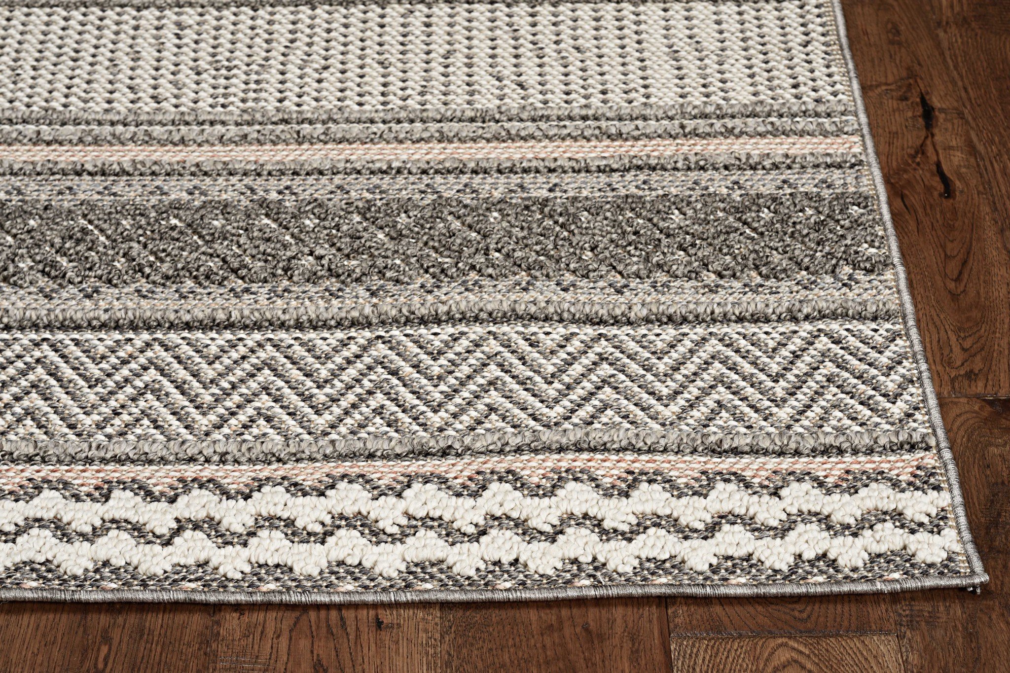 8-inch taupe machine woven tribal indoor outdoor runner rug with low pile height and UV-treated polypropylene material.