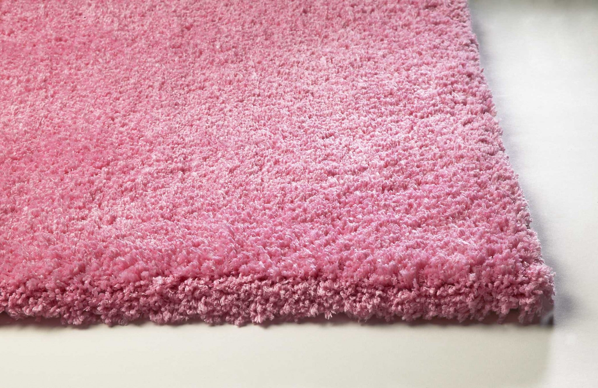 A vibrant 8x11 inches bright hot pink shag area rug, showcasing its plush texture and modern design, perfect for enhancing home decor.