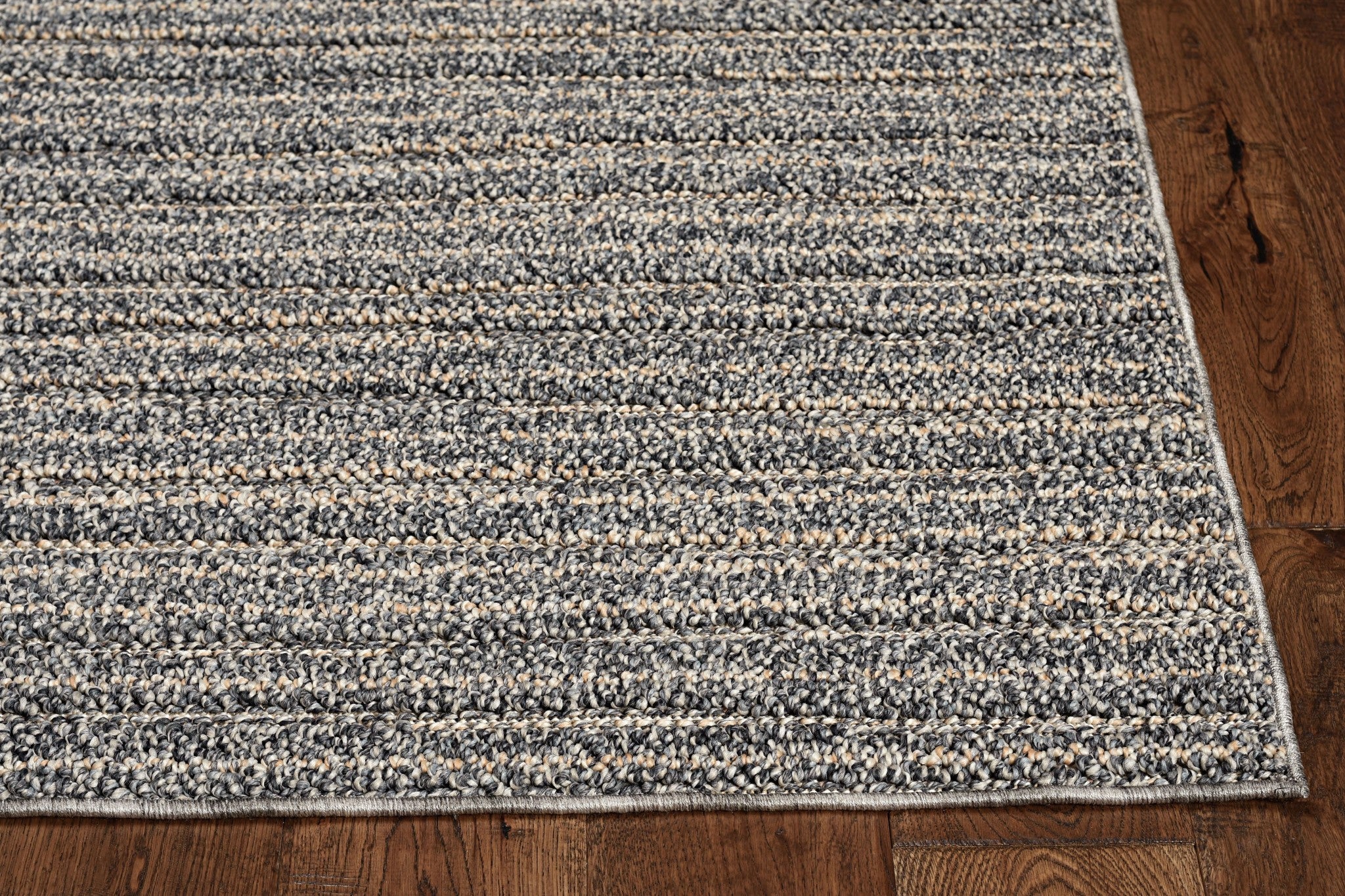 Denim blue machine woven rug, 8x10 inches, suitable for indoor and outdoor use, showcasing a low pile height and UV-treated material.