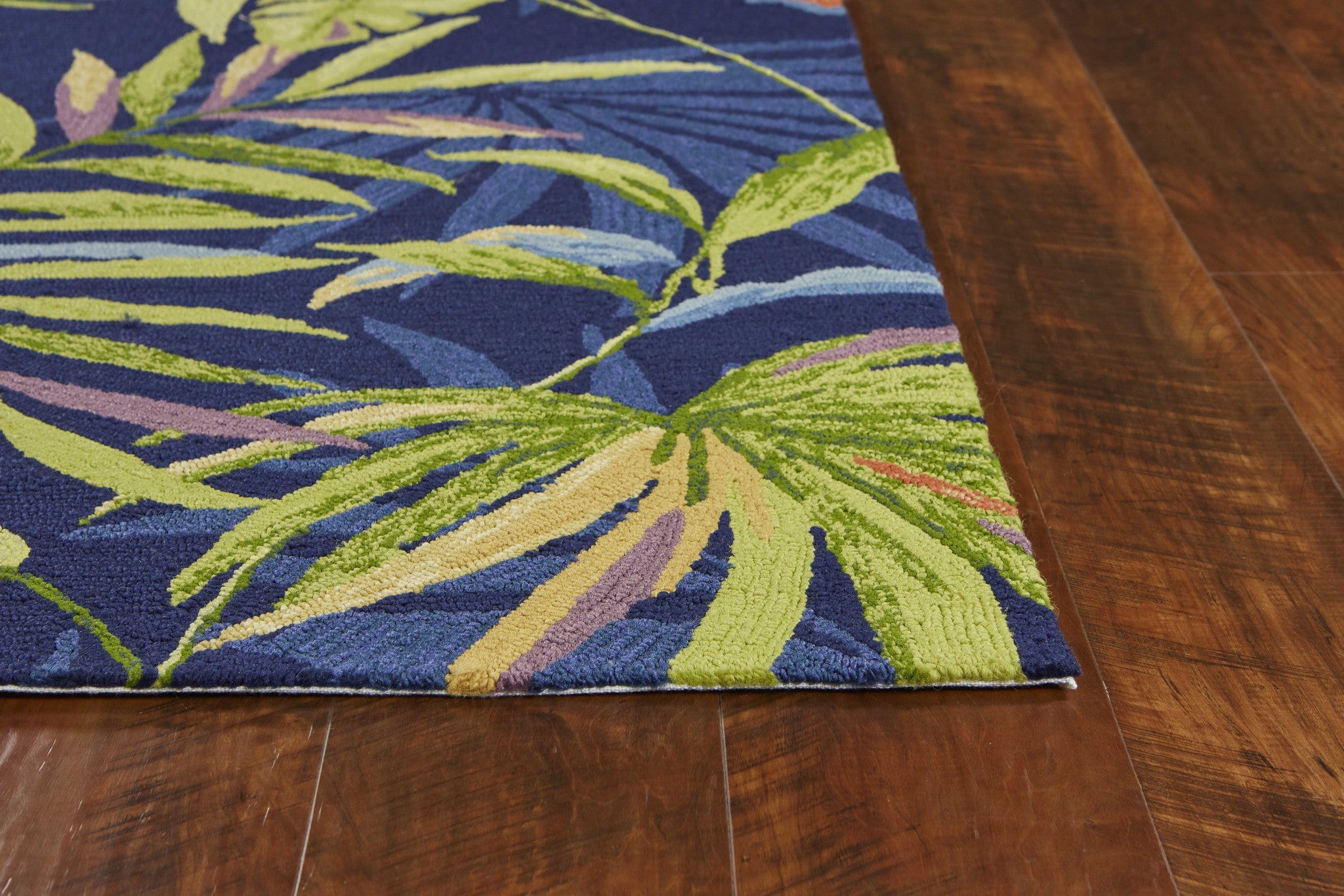 8x10 Ink Blue Hand Hooked UV Treated Oversized Tropical rug featuring intricate tropical leaf patterns, perfect for indoor and outdoor use.