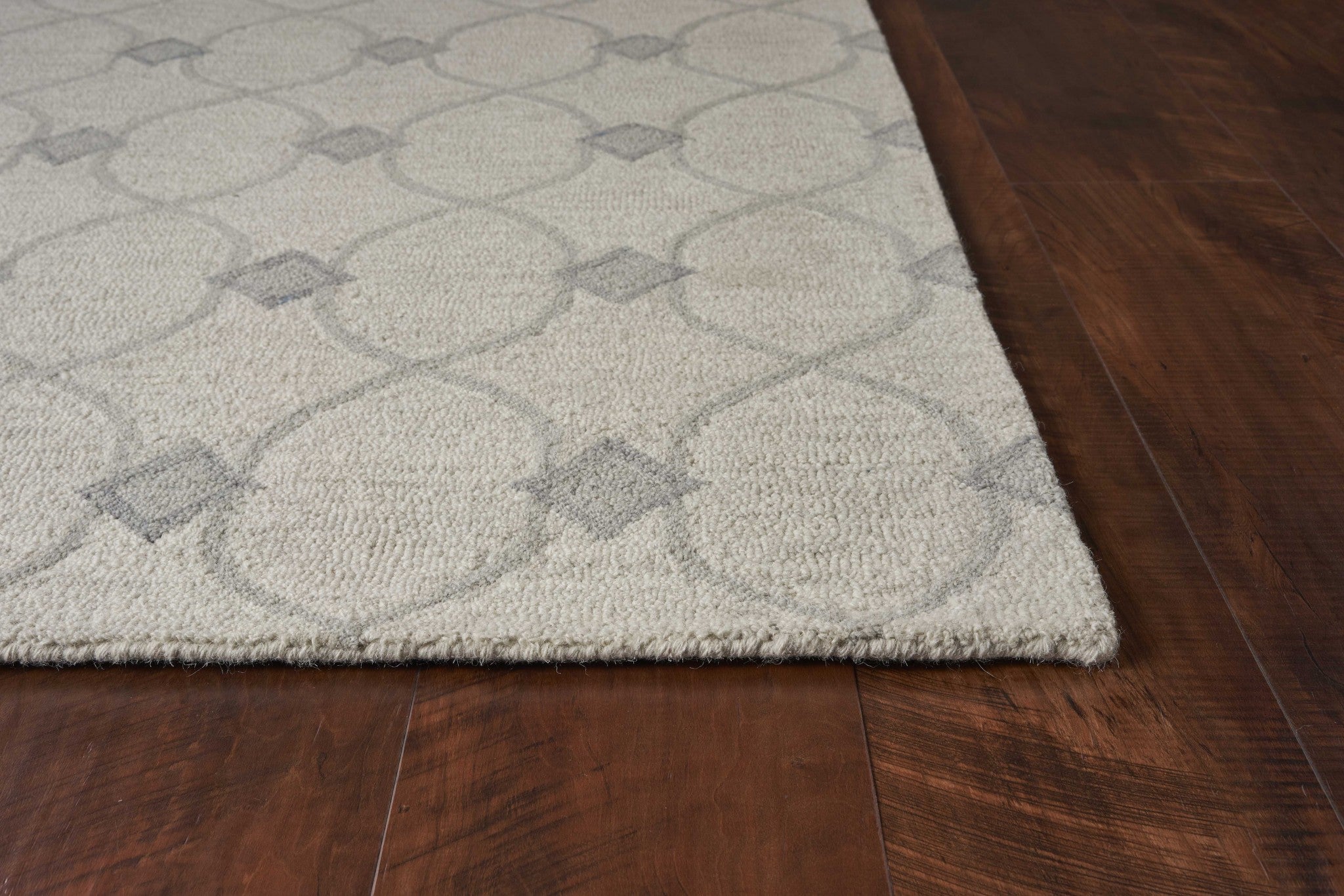 8 inches x 10 inches ivory hand-tufted ogee indoor area rug with a geometric design, showcasing its luxurious wool texture.