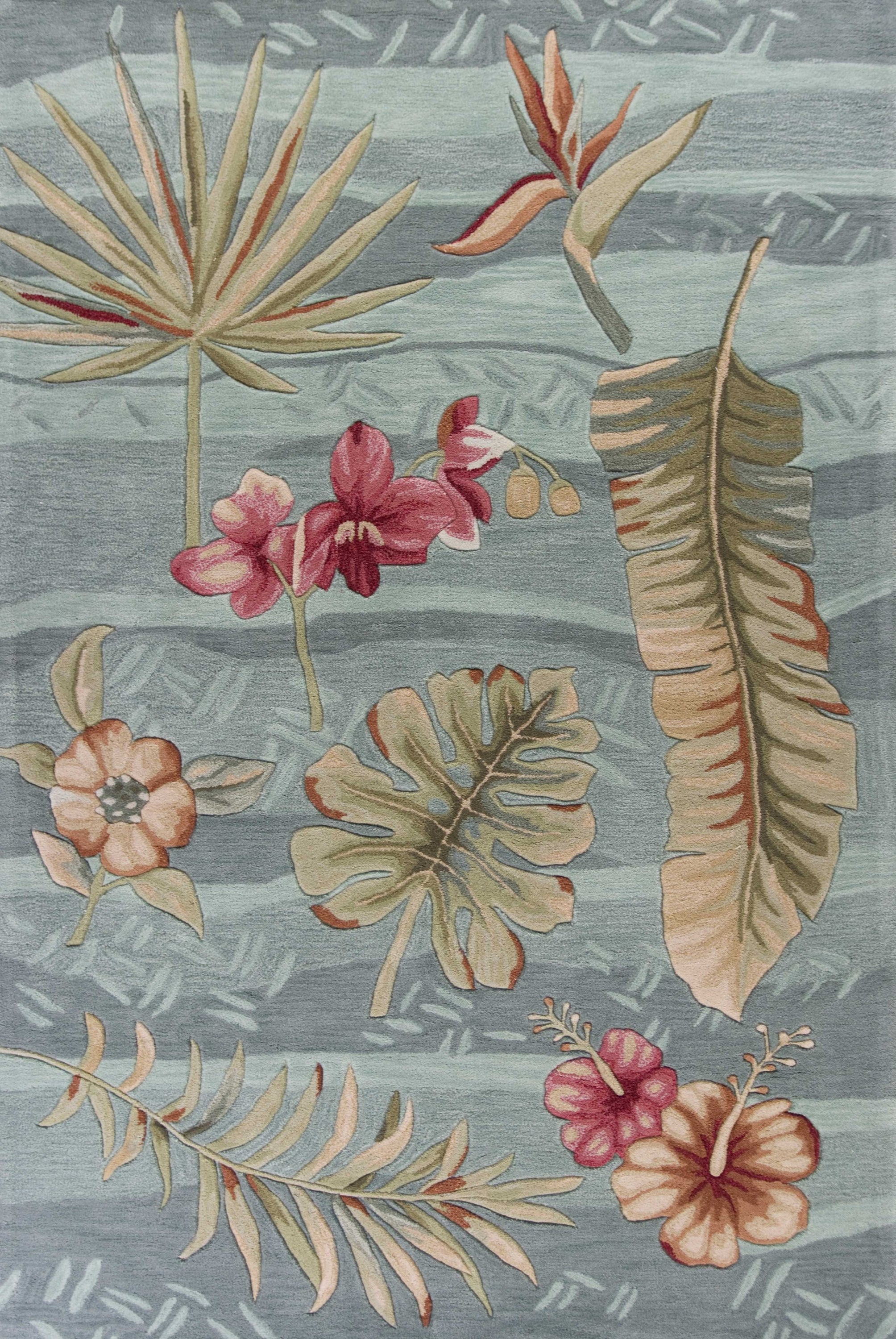 A vibrant seafoam green machine woven rug featuring tropical plant designs, perfect for indoor living spaces.