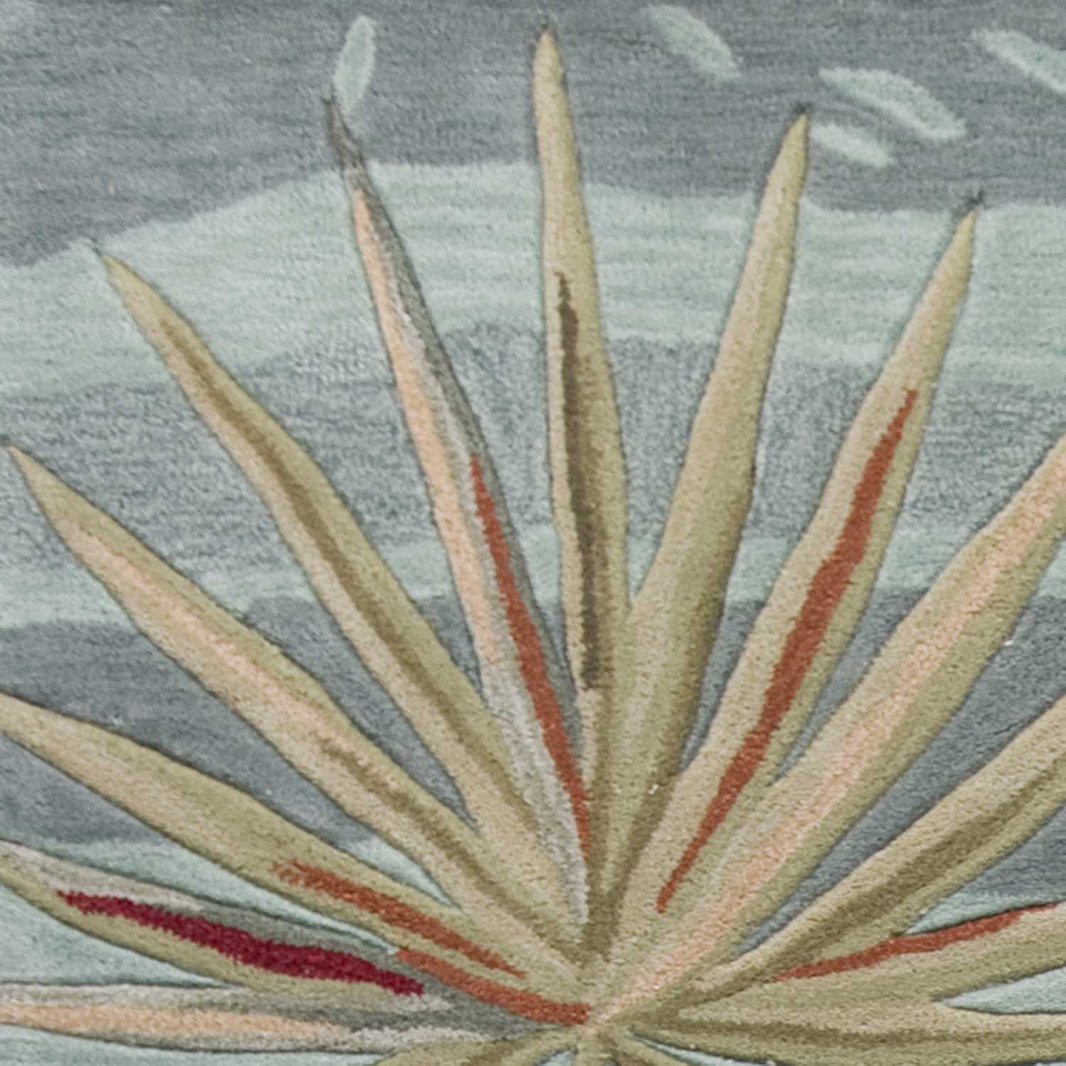 A vibrant seafoam green machine woven rug featuring tropical plant designs, perfect for indoor living spaces.