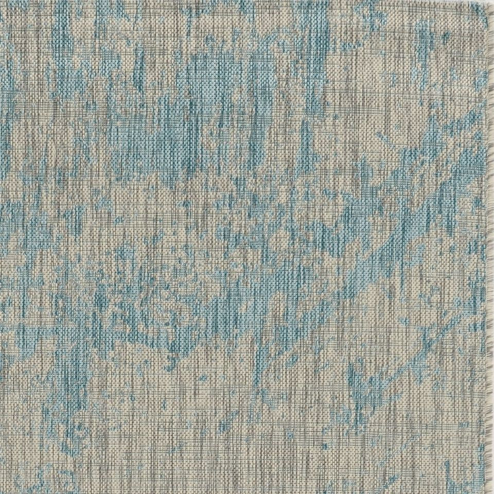 Teal machine woven abstract strokes rug, showcasing vibrant colors and modern design, suitable for indoor and outdoor use.