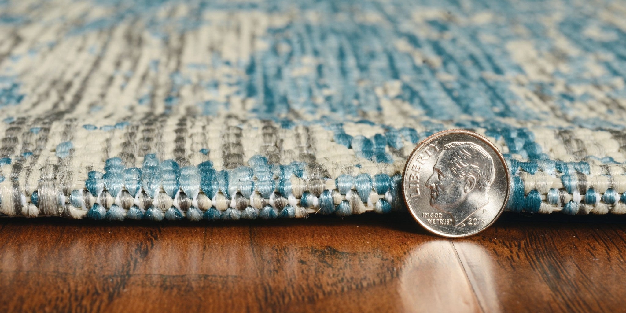 Teal machine woven abstract strokes rug, showcasing vibrant colors and modern design, suitable for indoor and outdoor use.