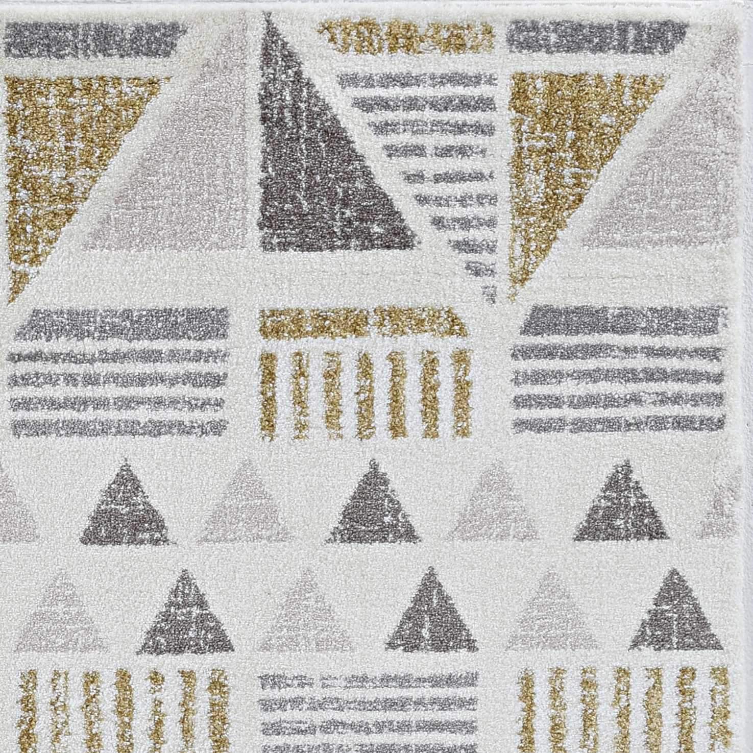 A luxurious 94" X 130" ivory and gold polyester rug with unique geometric patterns, showcasing plush fibers and elegant design.