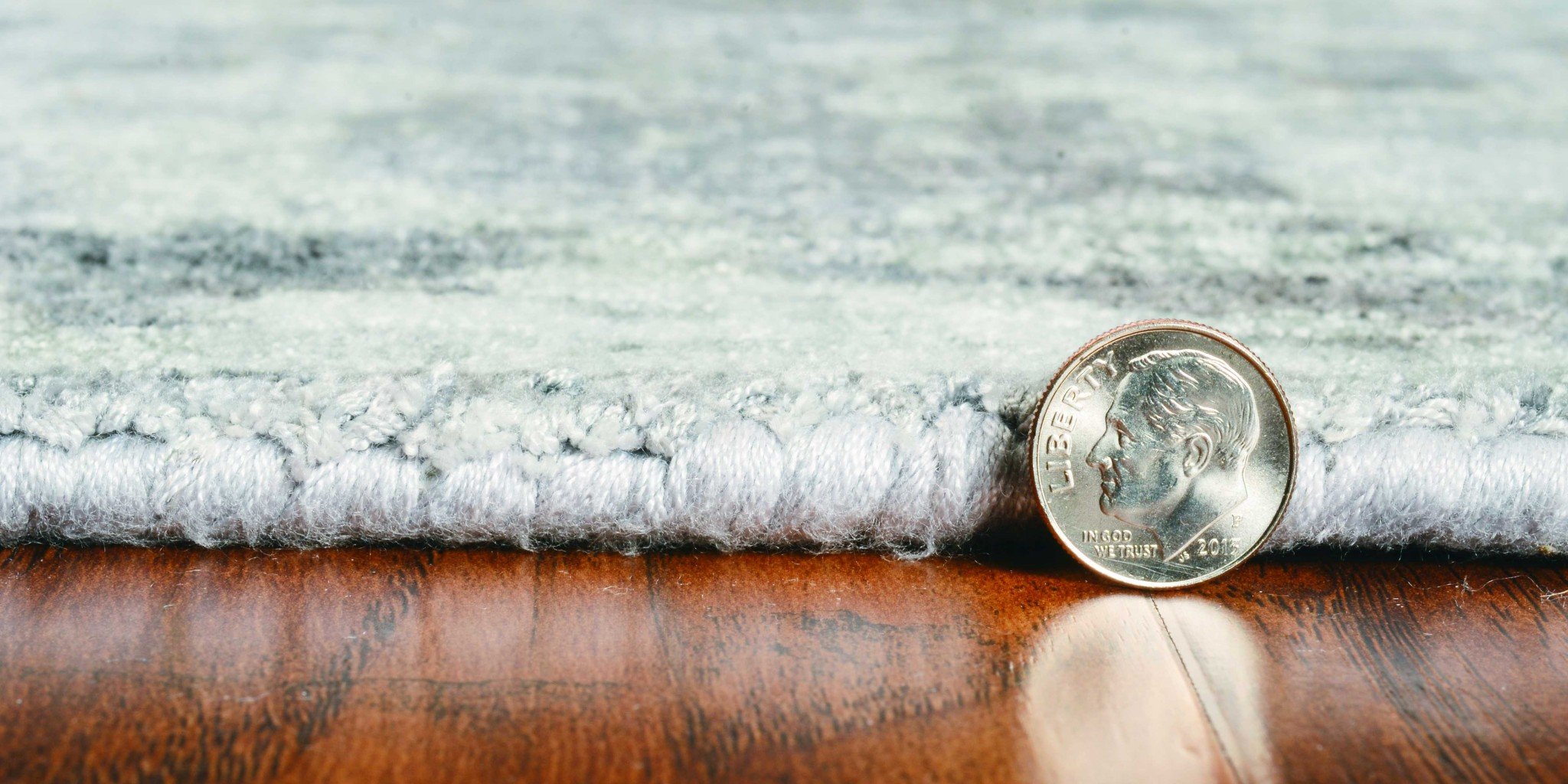 A beautiful 9x13 grey hand-loomed traditional indoor area rug showcasing intricate tonal and watercolor patterns, perfect for enhancing home decor.