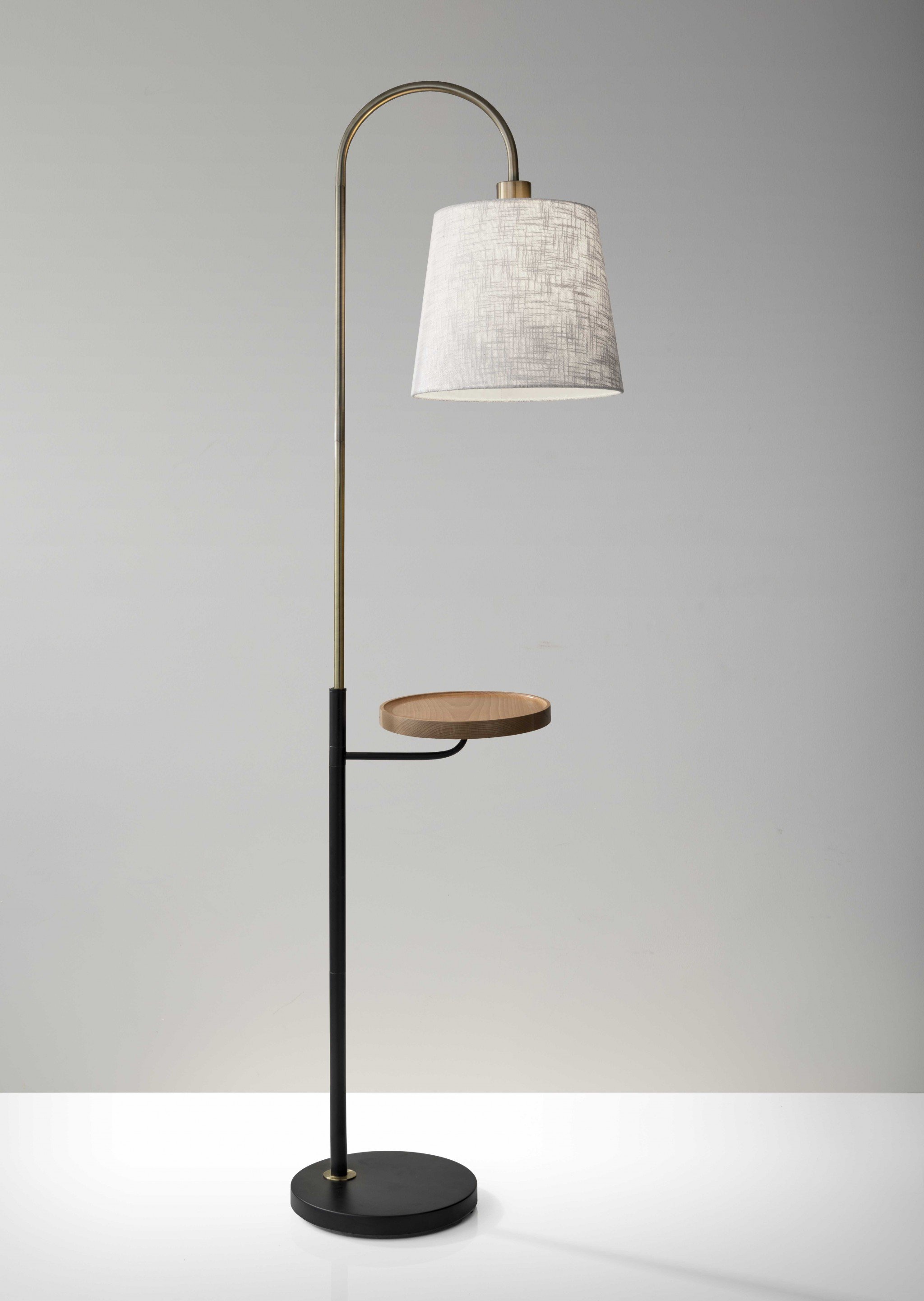 Antique brass and black metal floor lamp with USB charging station and natural wood shelf, featuring a textured off-white fabric shade.
