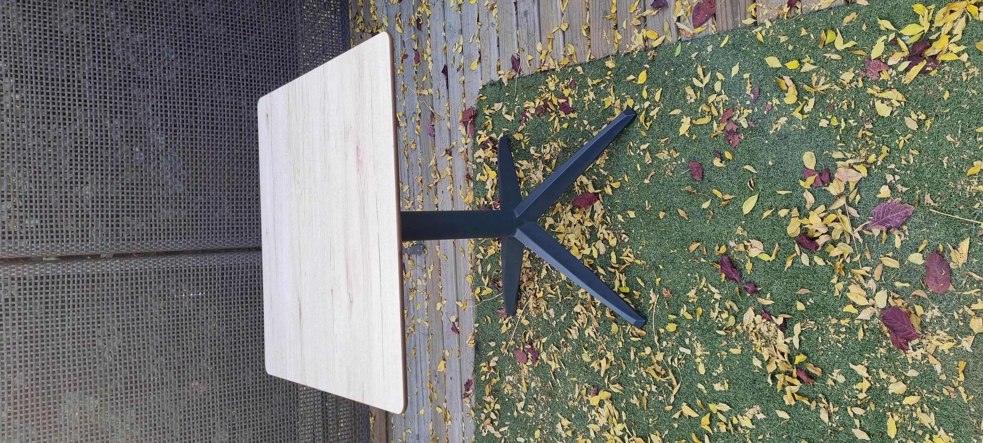 Bistro Table 28 X 28 with a dark grey base and white or oak laminate top, perfect for outdoor dining.