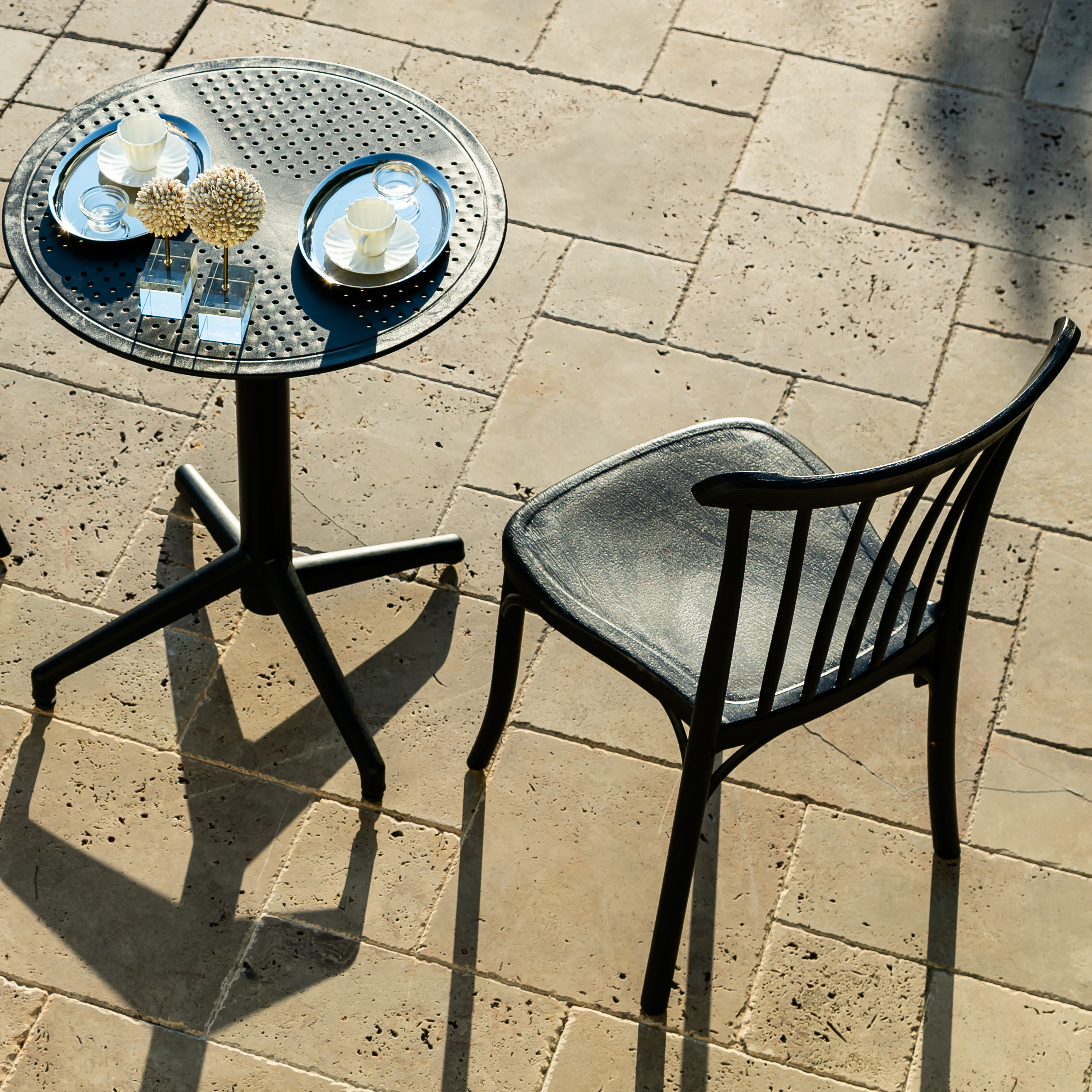 Bistro Table Fiona Ø24" in black, featuring a round fiberglass reinforced top and sturdy cross base, perfect for outdoor dining.
