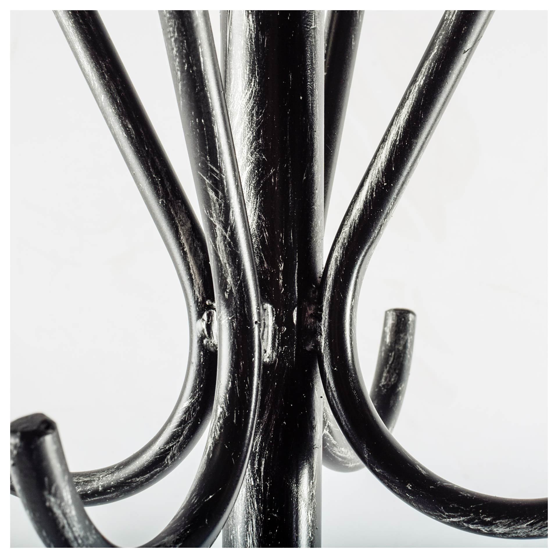 A sleek black metal coat rack featuring multiple hooks and a base for umbrella storage, ideal for entryways.