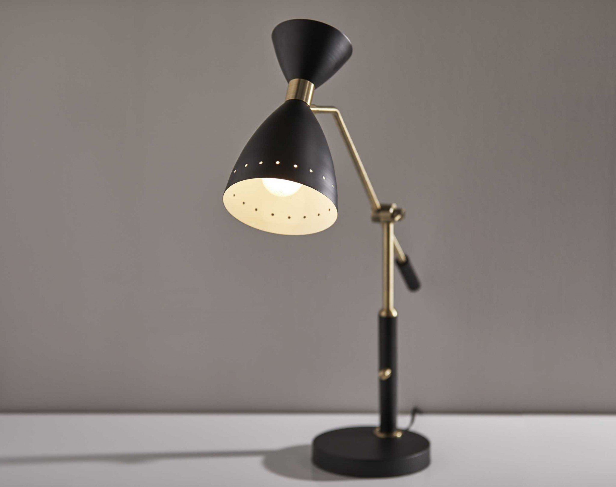 Brass Cinch Black Metal Adjustable Desk Lamp with oversized shade and adjustable arm, showcasing mid-century modern design.