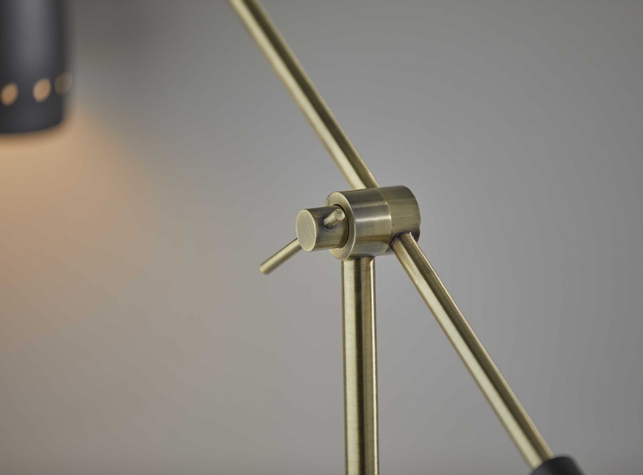 Brass Cinch Black Metal Adjustable Desk Lamp with oversized shade and adjustable arm, showcasing mid-century modern design.