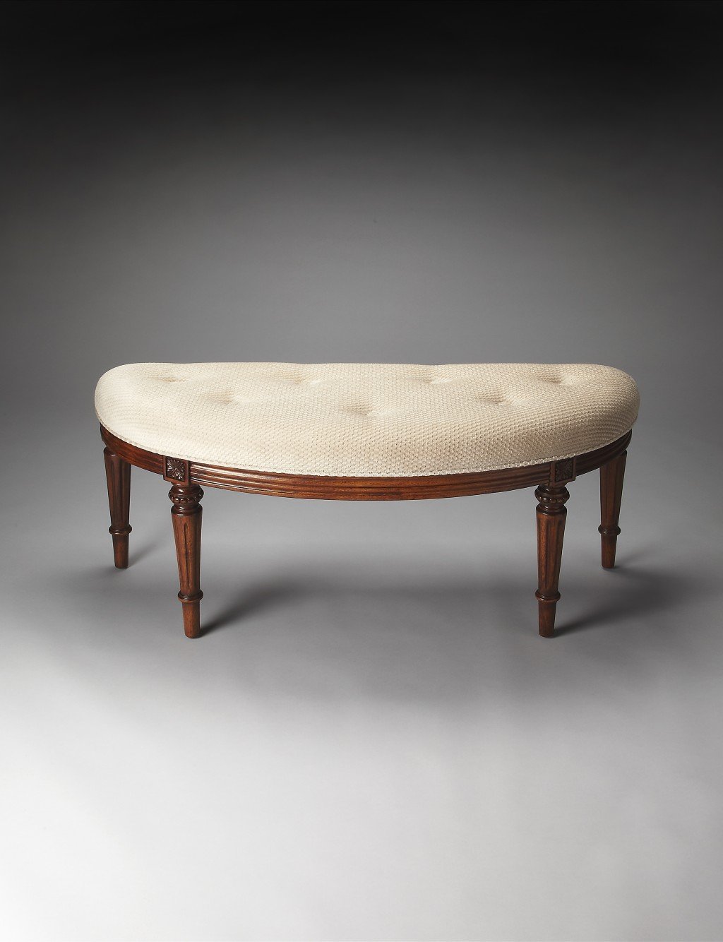 Elegant crescent shape ivory tufted bench with olive ash burl finished legs, perfect for dressing rooms and foyers.