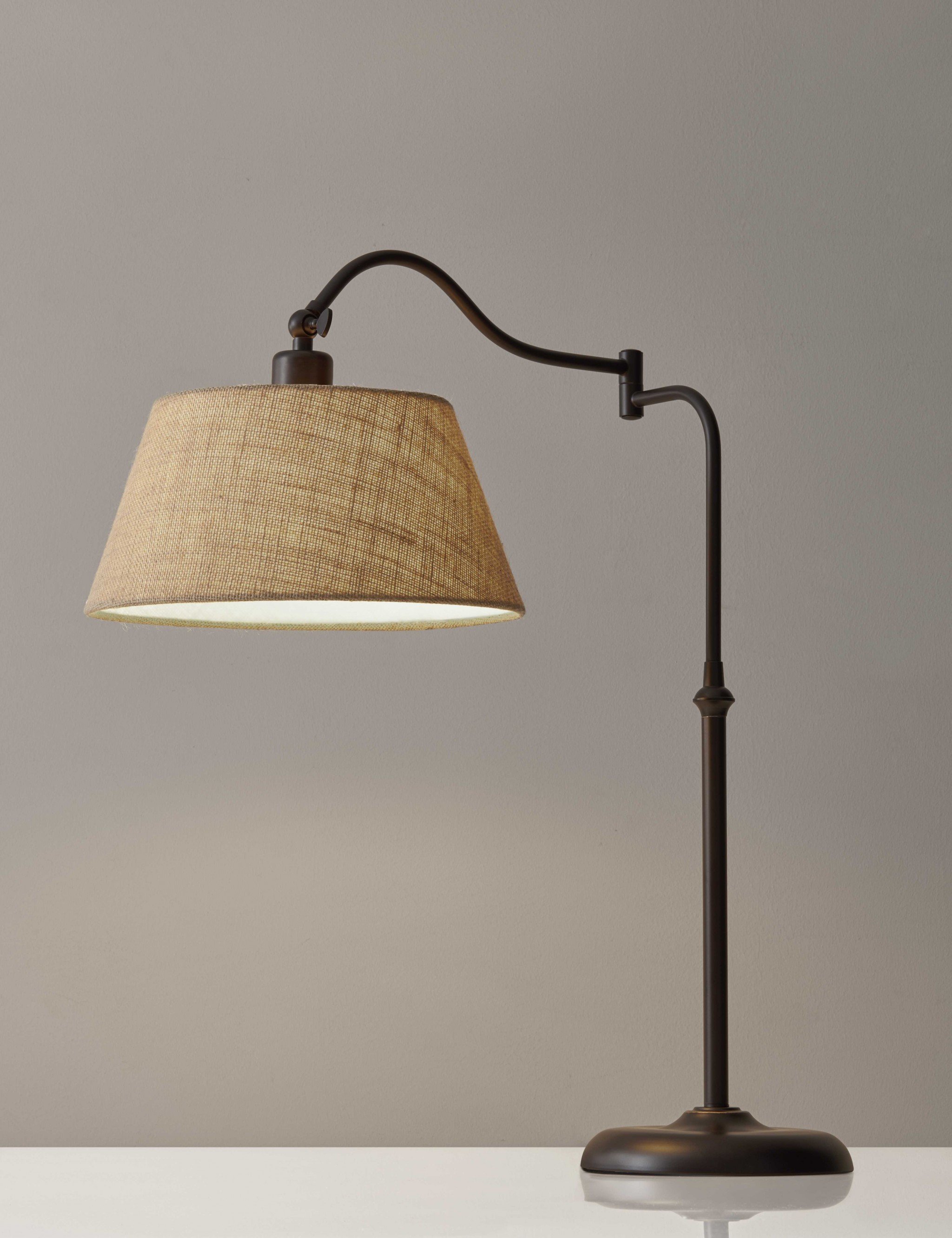 Dark bronze metal swing arm adjustable table lamp with burlap shade, showcasing modern design and functionality.