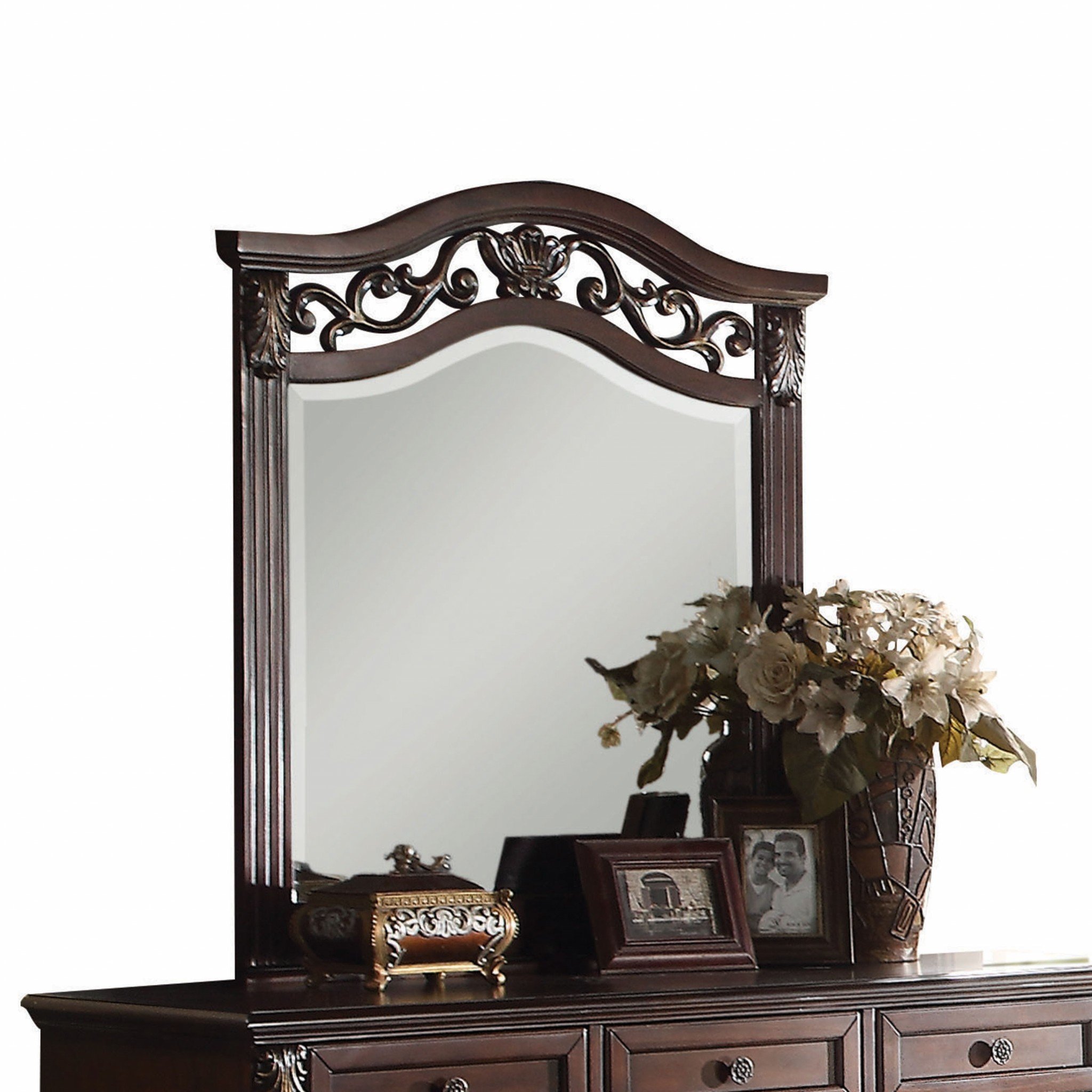 A beautifully crafted dark walnut wood finish wall mirror with beveled edges and intricate cursive carvings, perfect for traditional decor.