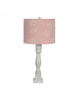 Distressed white table lamp with an olive branch pink shade, showcasing elegant design and calming ambiance.