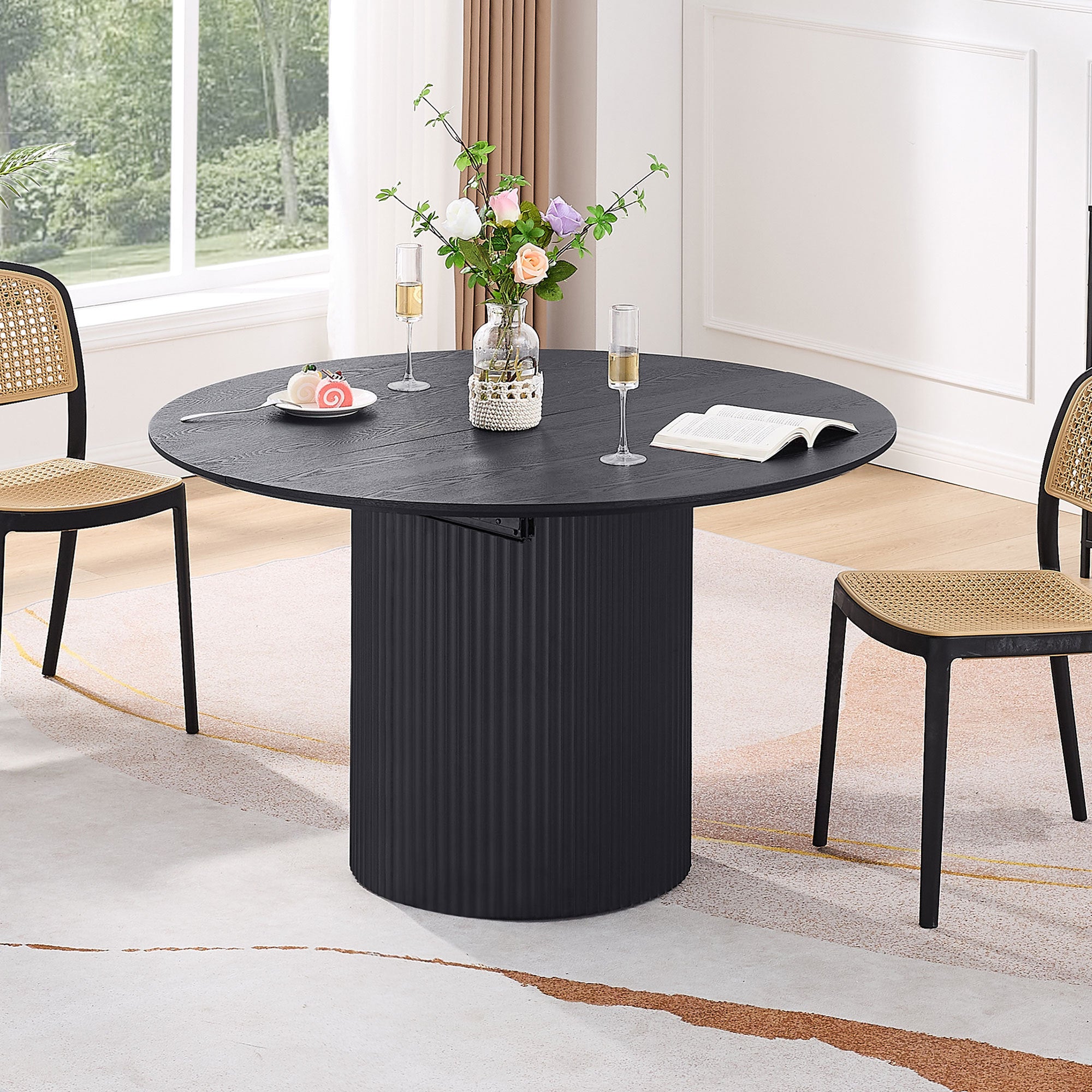 Expandable dining table with a solid black top, designed to extend for additional seating, showcasing a modern and elegant style.