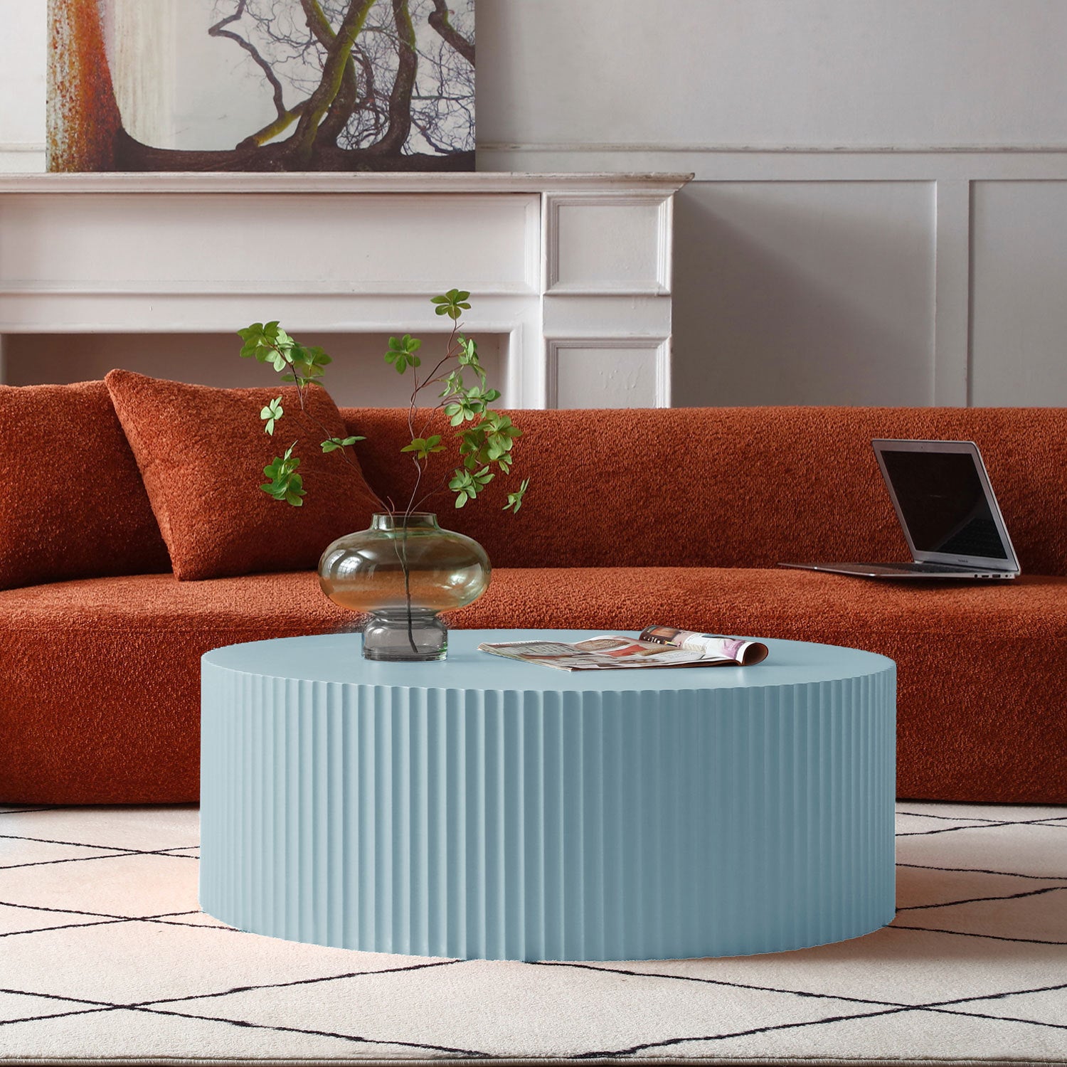 Handcrafted round coffee table in light blue with elegant relief detailing, showcasing its smooth finish and stylish design.