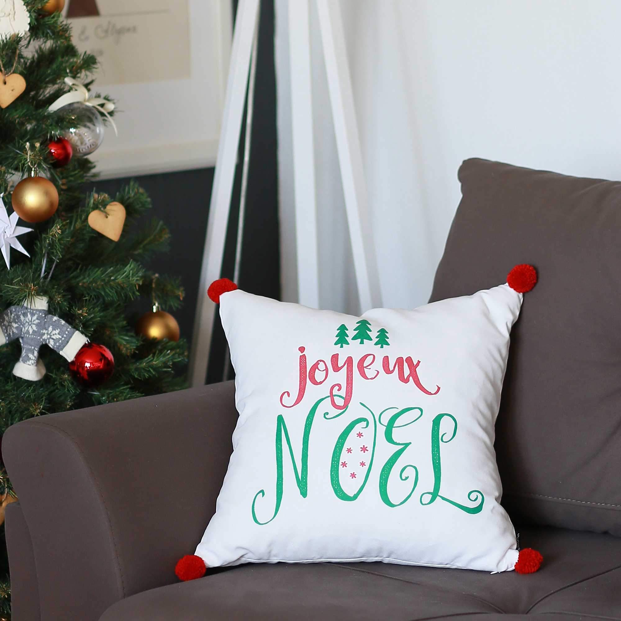 Joyeux Noel Square Printed Decorative Throw Pillow Cover with vibrant Christmas design and red pompoms, showcasing luxurious brushed fabric.