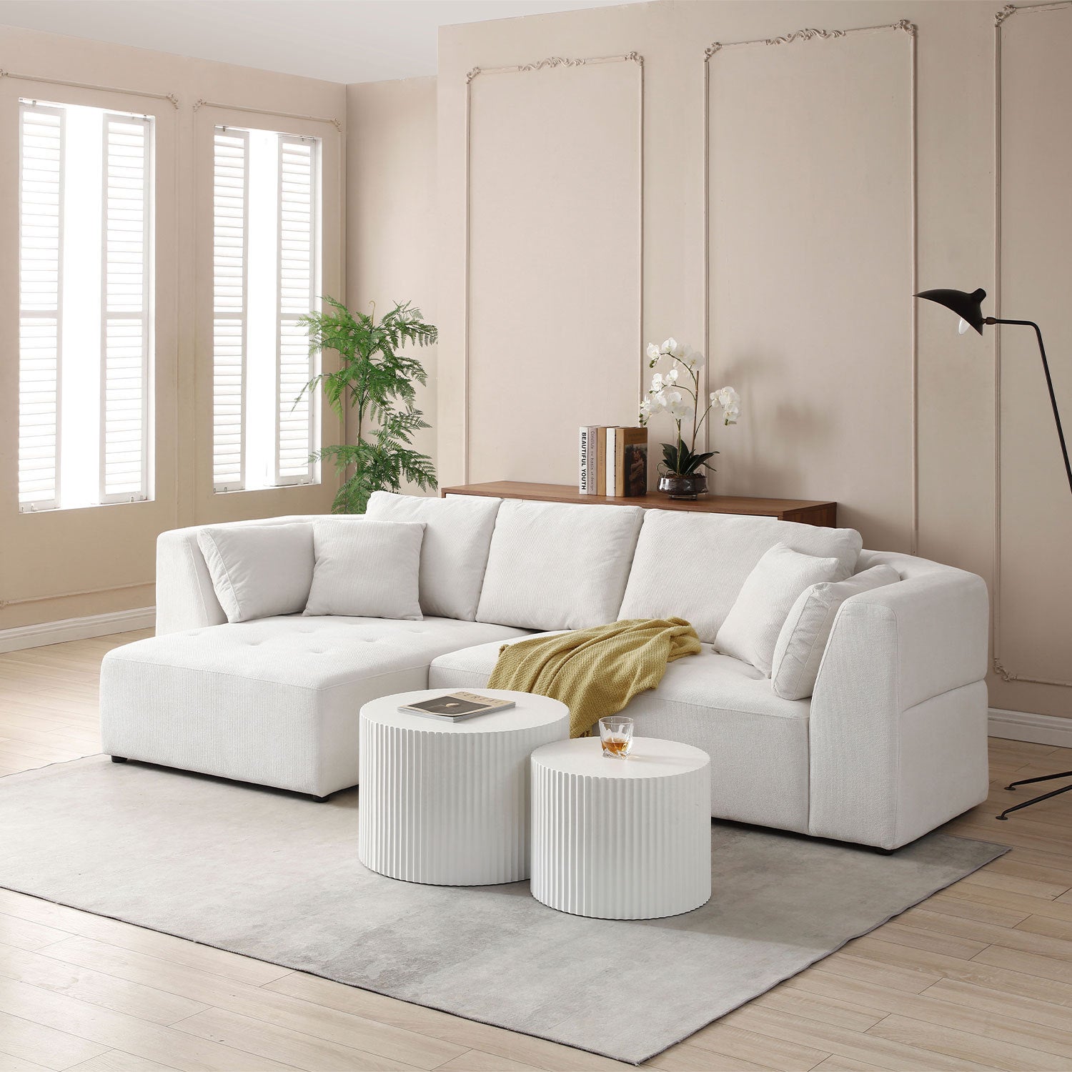 Beige L-shape sectional sofa with left-facing chaise, featuring thick cushions and a modern design, perfect for stylish living rooms.