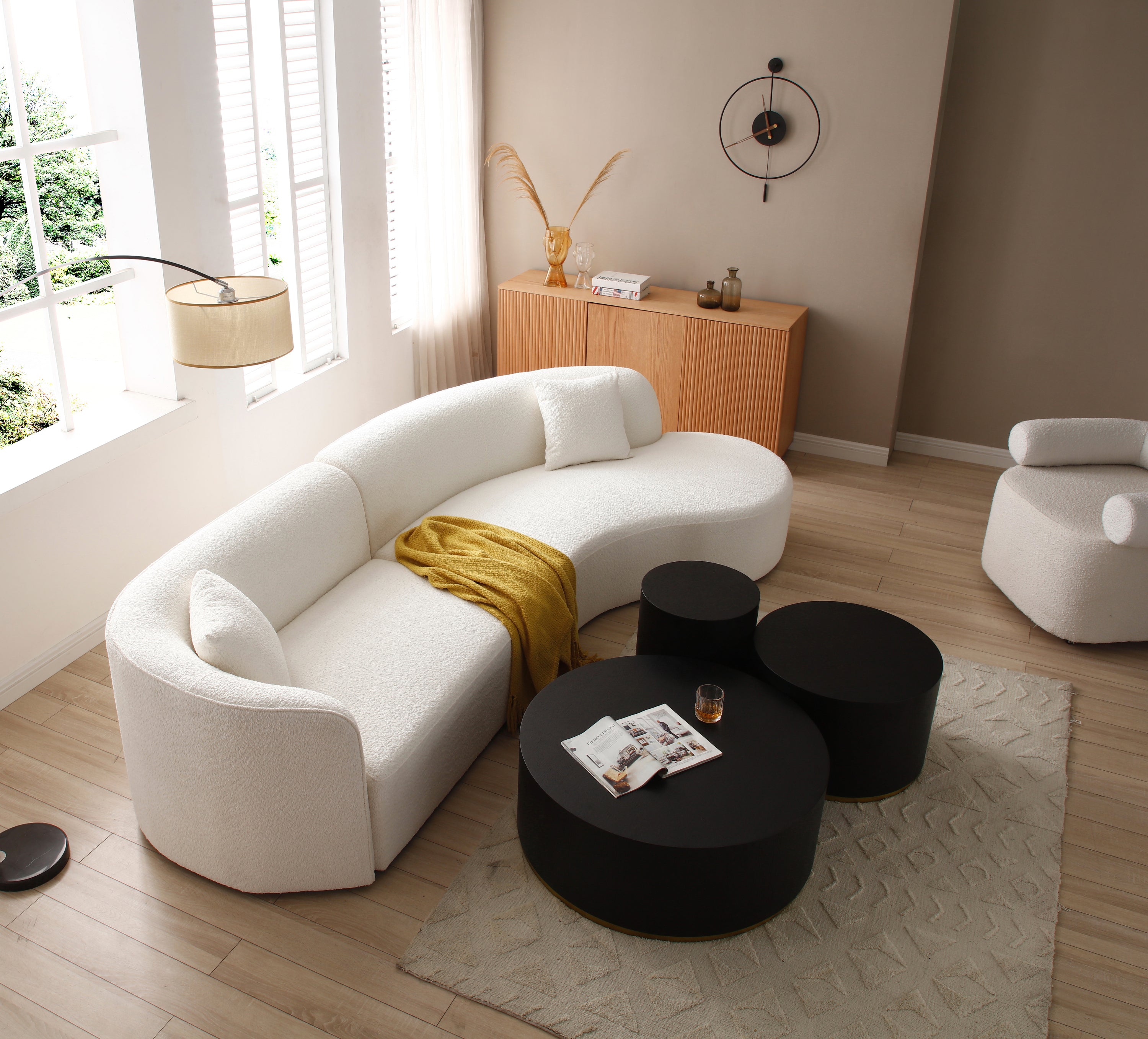 Luxury modern curved sofa with chaise in white boucle fabric, showcasing elegant design and plush seating.