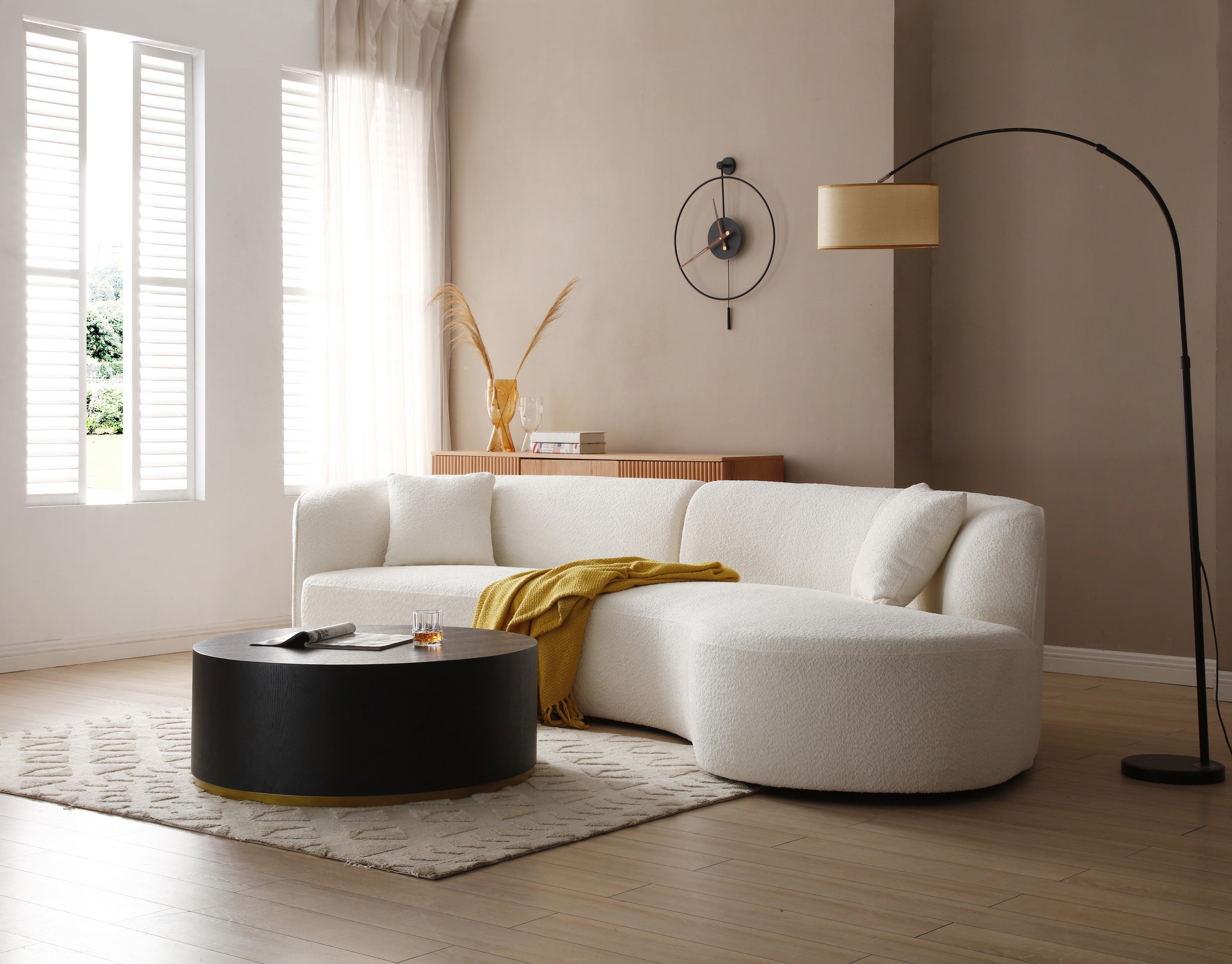 Luxury modern curved sofa with chaise in white boucle fabric, showcasing elegant design and plush seating.