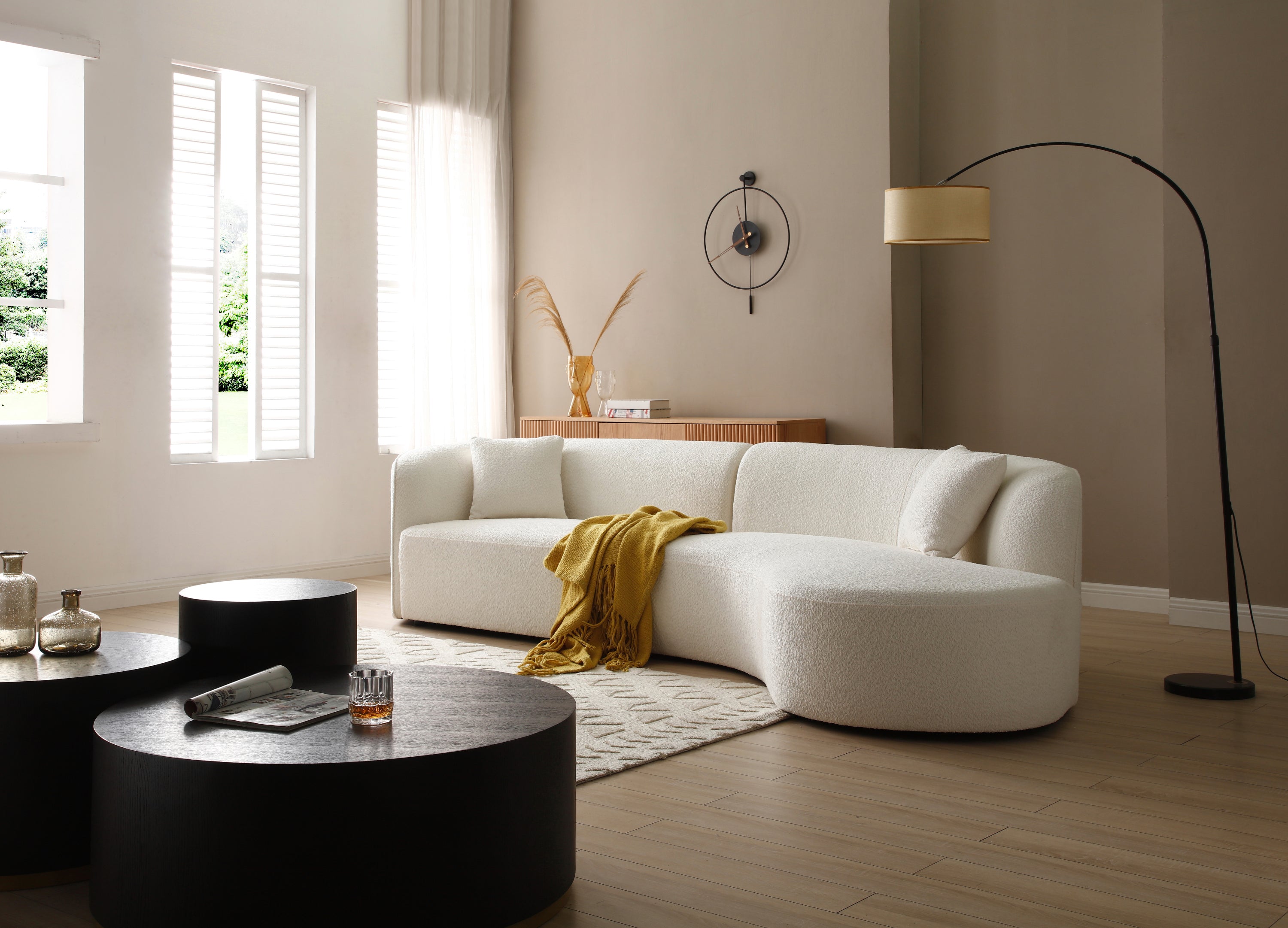 Luxury modern curved sofa with chaise in white boucle fabric, showcasing elegant design and plush seating.