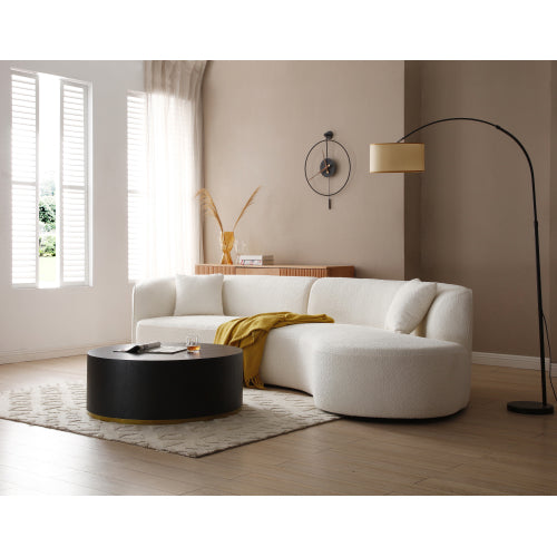 Luxury modern curved sofa with chaise in a stylish living room setting, featuring soft boucle fabric and elegant design.
