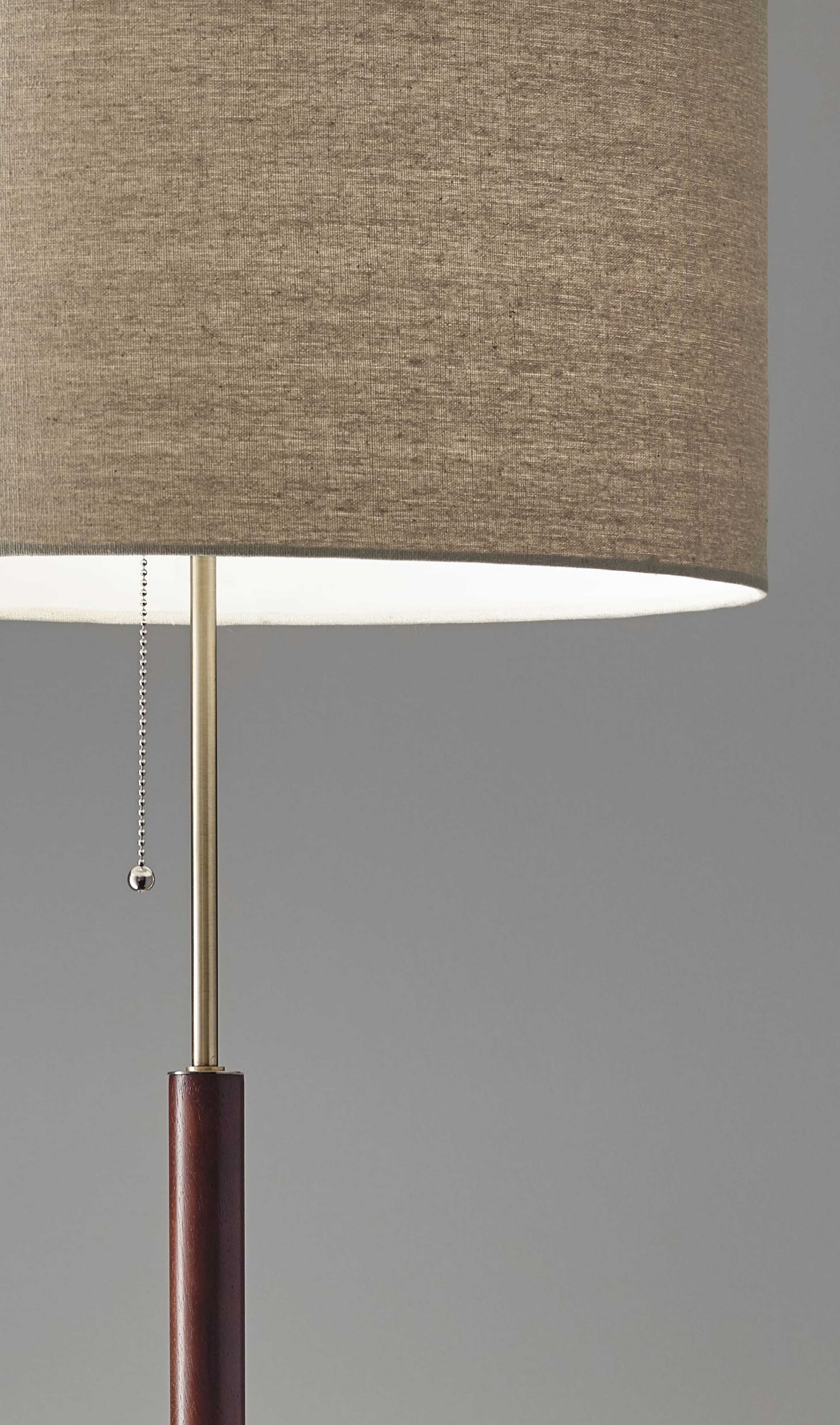 Mid-Century Modern Floor Lamp featuring antique brass and walnut wood finishes with a natural linen shade.
