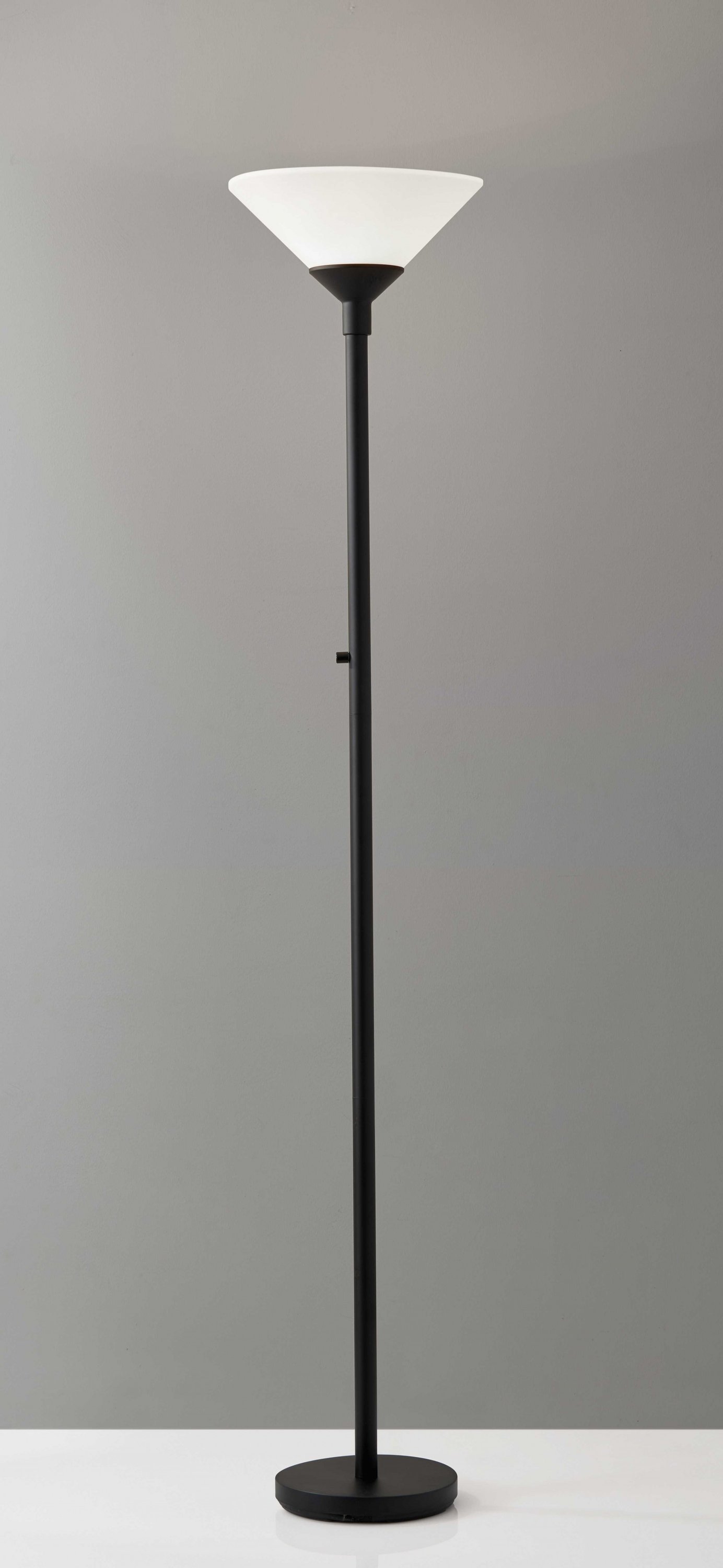 Mod Blackened Metal Torchiere floor lamp with a matte black finish and tapered frosted shade, providing ambient lighting.