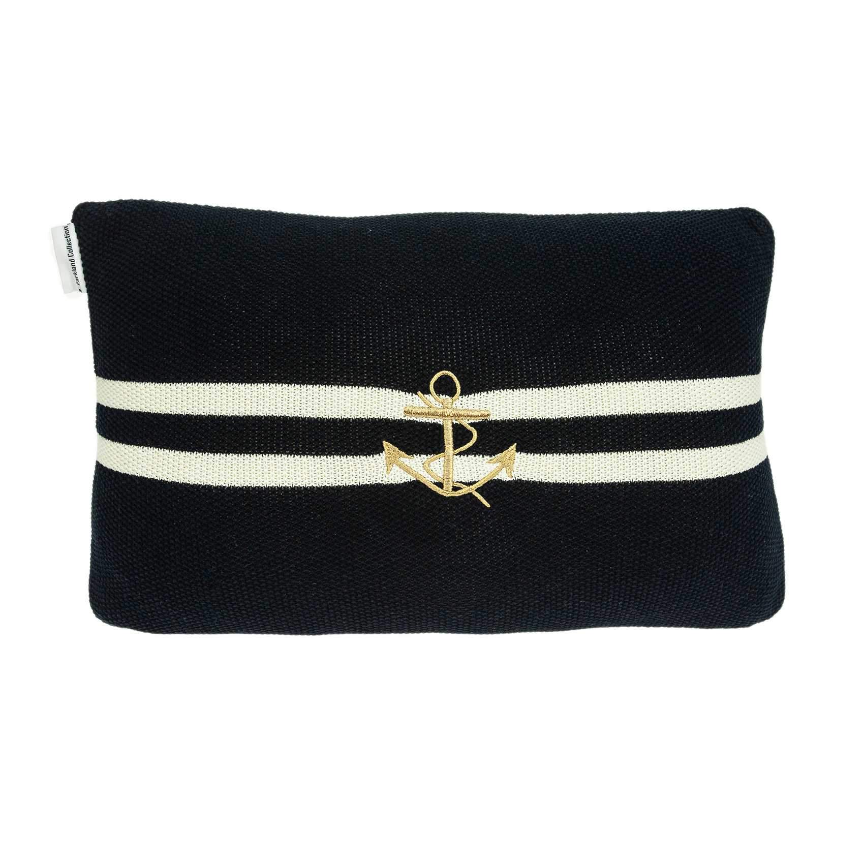 Navy blue decorative pillow featuring a gold anchor pattern, perfect for coastal home decor.