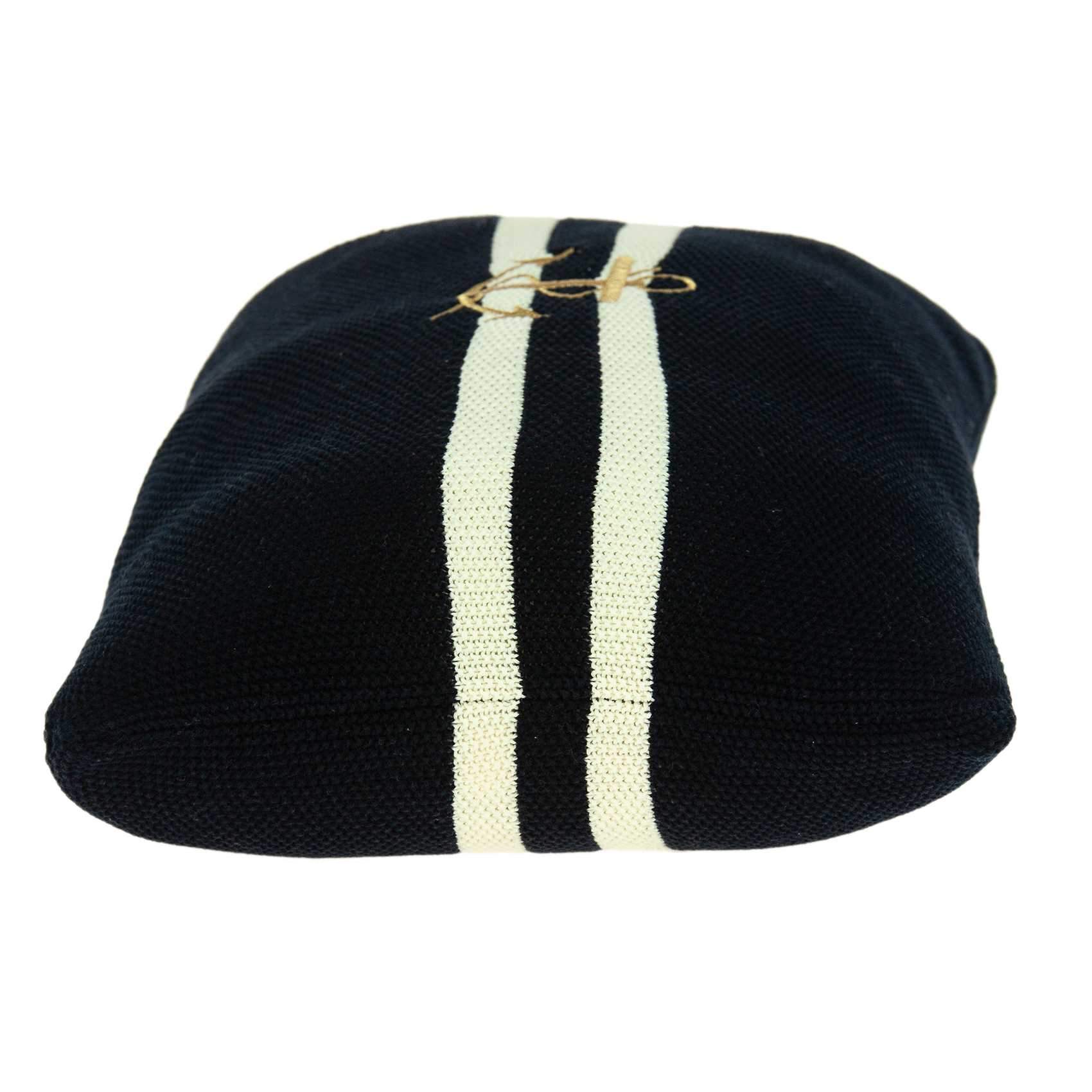 Navy blue decorative pillow featuring a gold anchor pattern, perfect for coastal home decor.