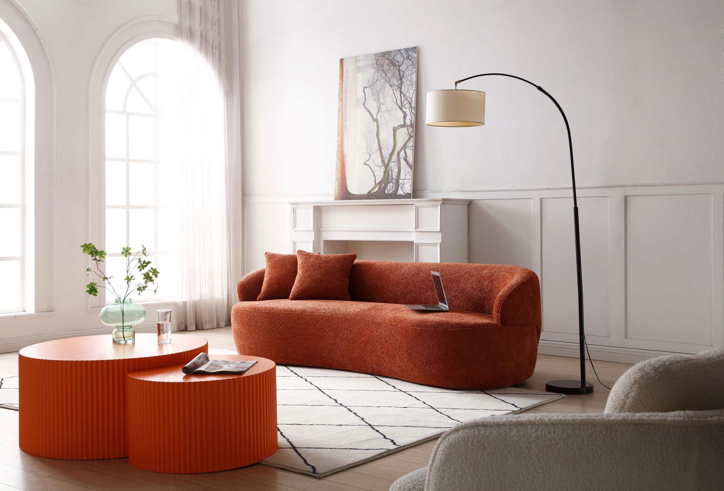 A stylish ORANGE Mid Century Modern Curved Sofa featuring a soft Boucle fabric, designed for comfort and elegance in a living room setting.